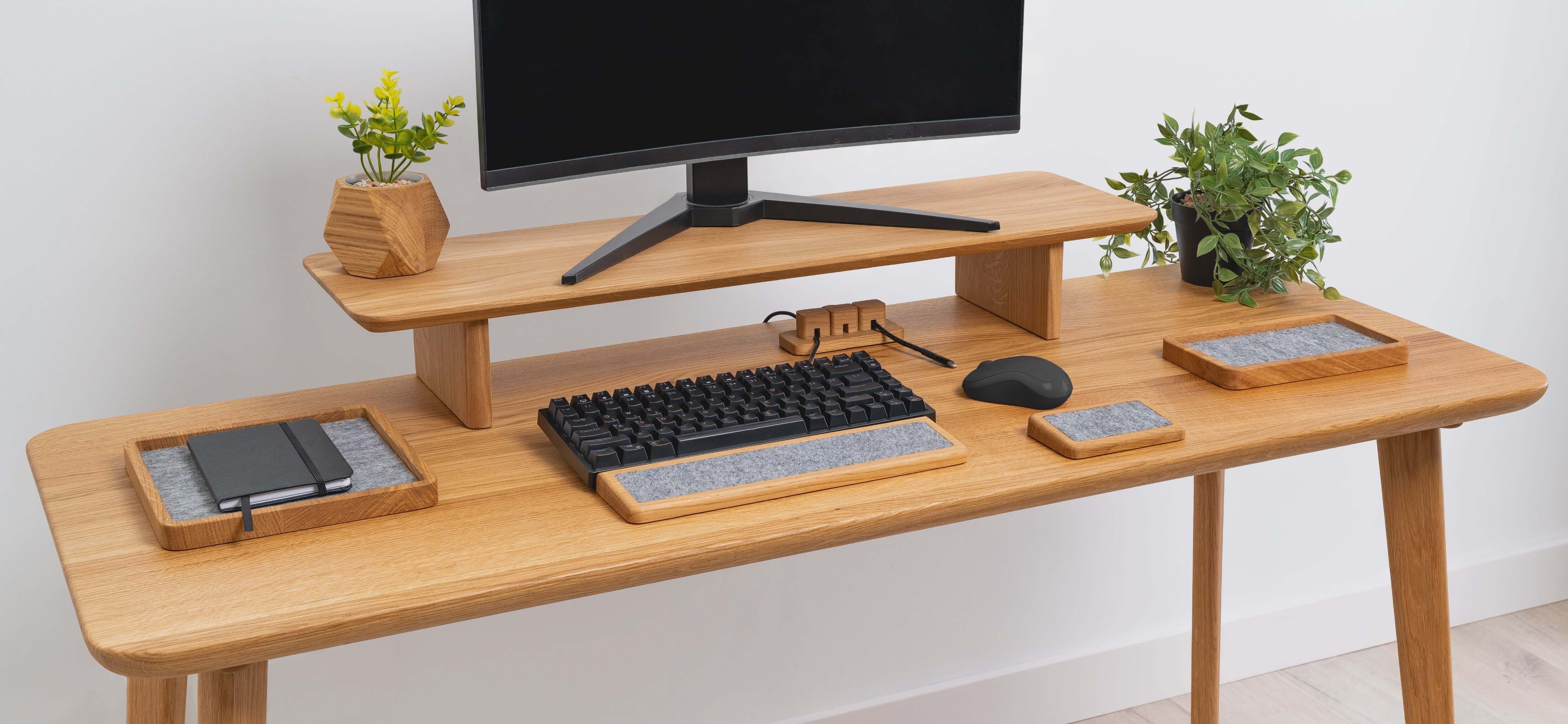 Wooden Table Top with computer setup, keyboard, mouse, and greenery for a stylish workspace.