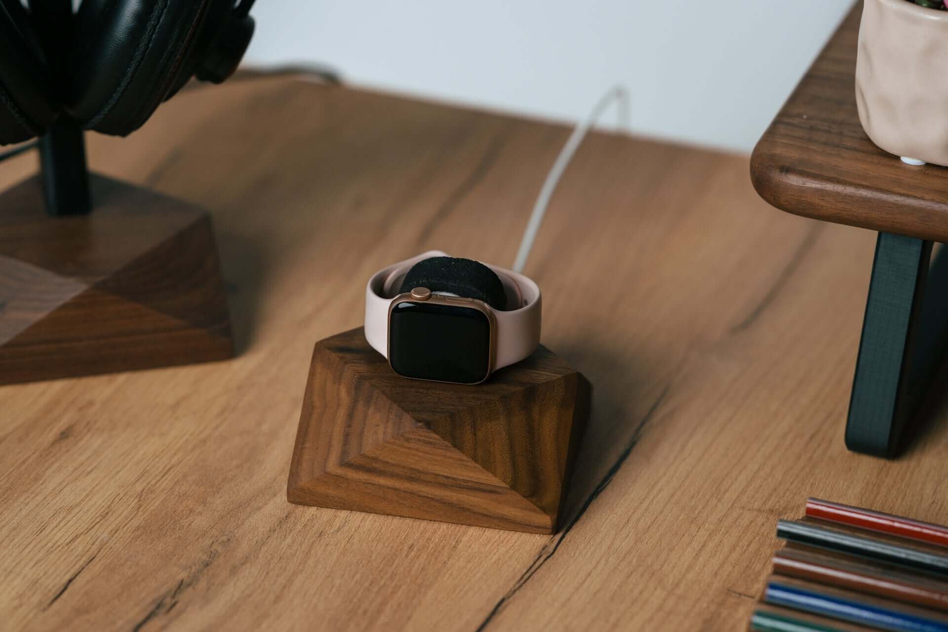 Apple Watch charging stand in walnut wood with a smartwatch resting, perfect for organization and style.