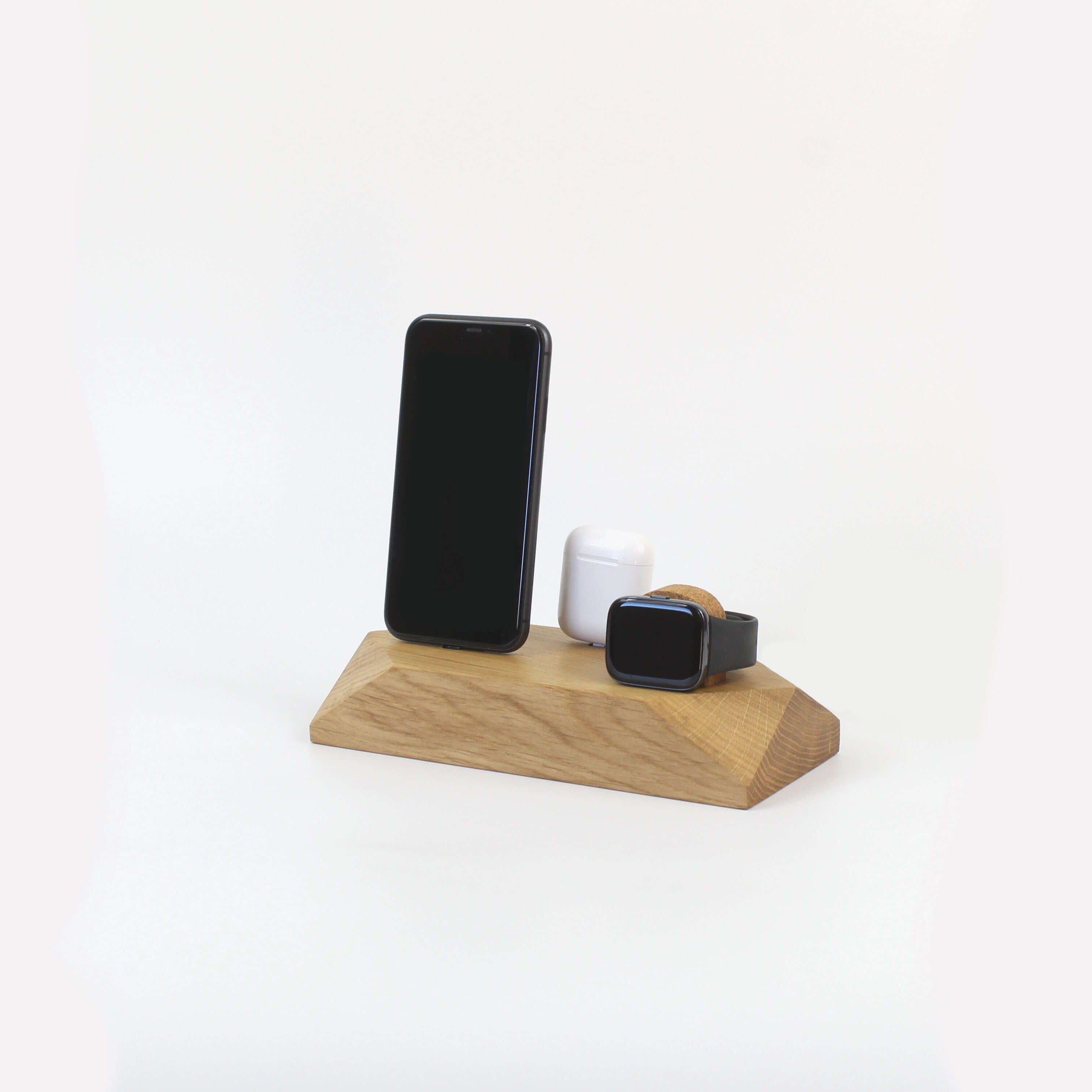 Triple Docking Station in oak, holding two smartphones and an Apple Watch, a sleek 3-in-1 charging solution for phone accessories.