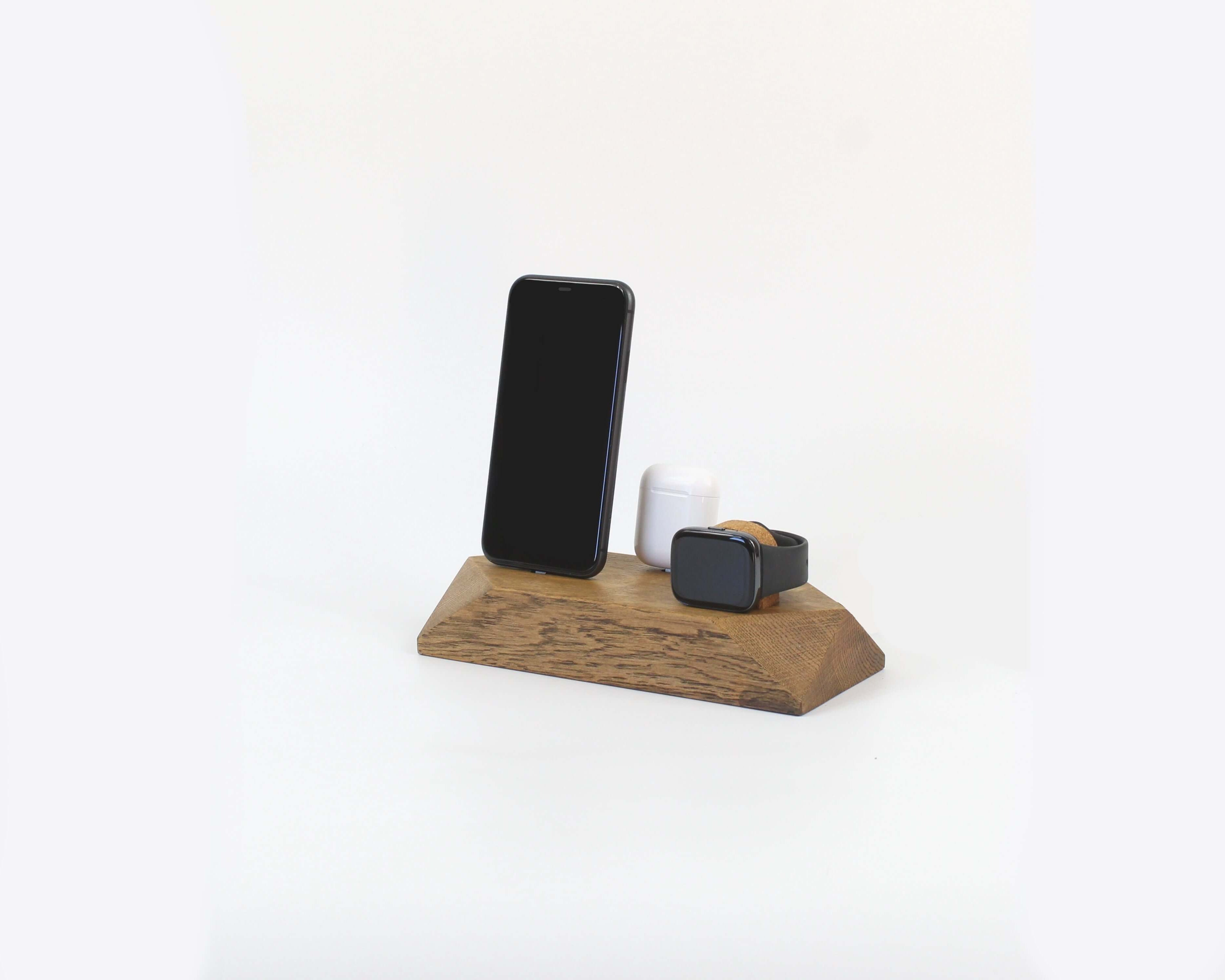 Triple Docking Station in brown oak, holding two smartphones and an Apple Watch, perfect for organization and style.