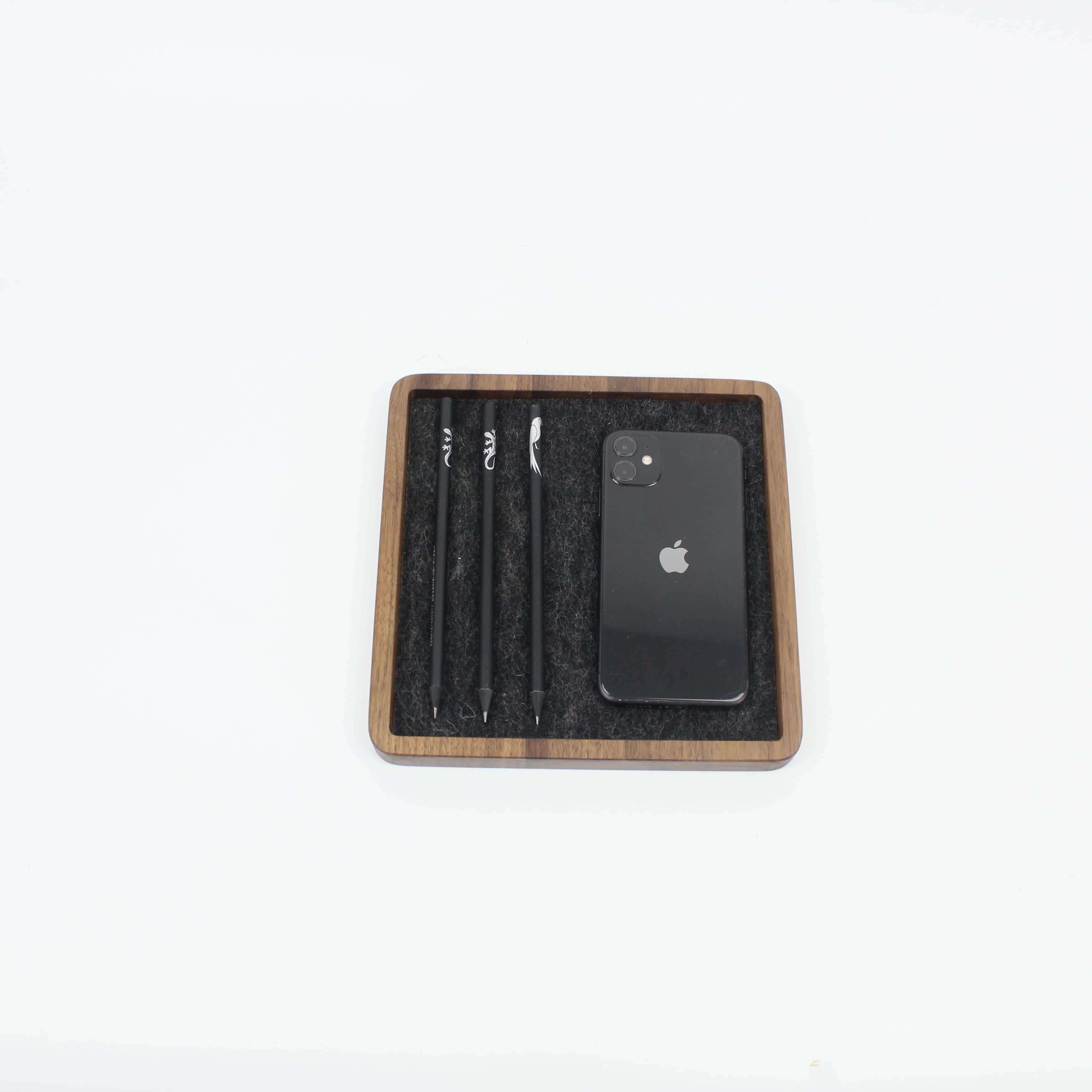 Square walnut Catch All Tray with pens and smartphone, ideal for desk organization and stylish storage.