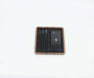 Square walnut Catch All Tray with pens and smartphone, ideal for desk organization and stylish storage.