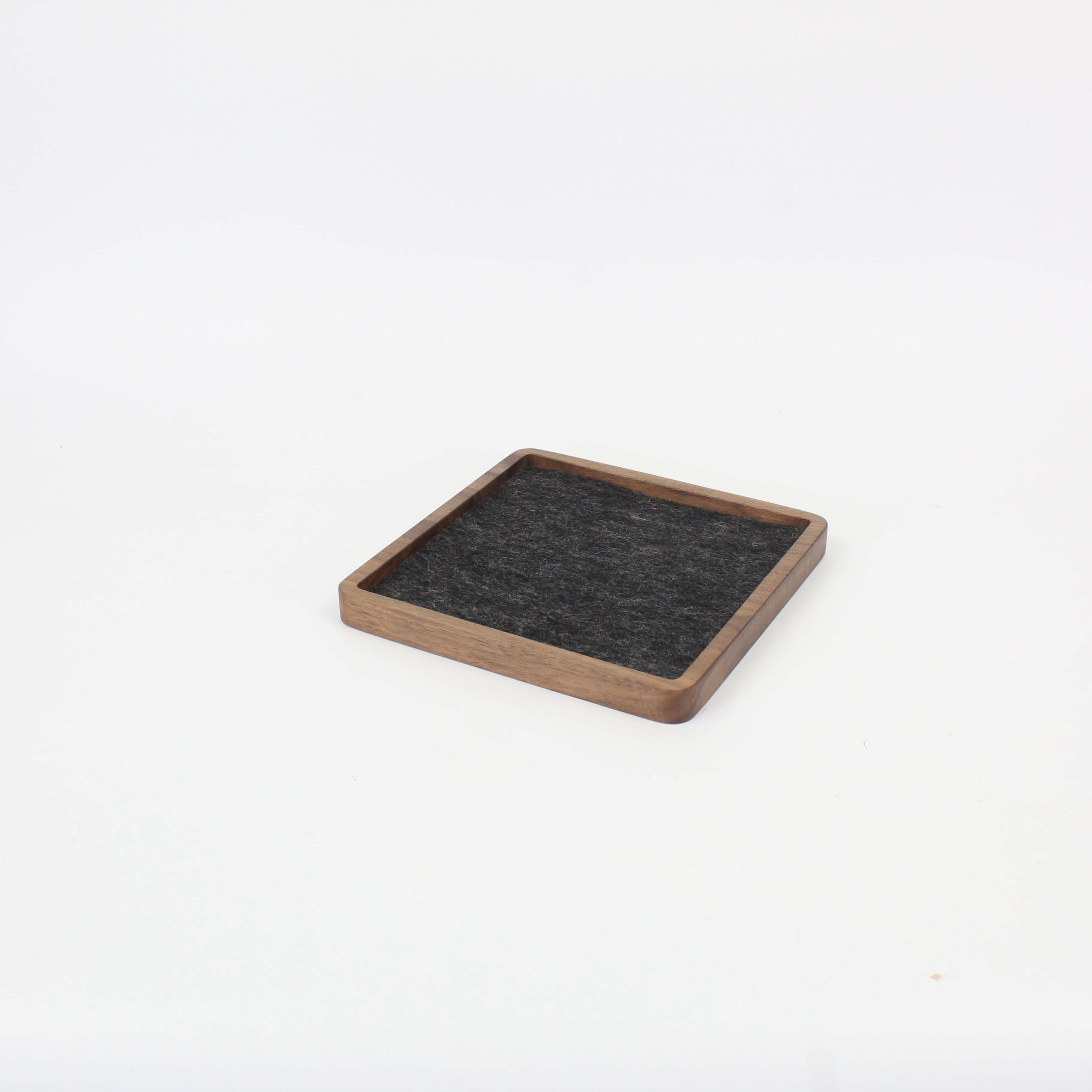 Square walnut catch all tray with felt lining, ideal for organizing desk essentials and enhancing workspace aesthetics.