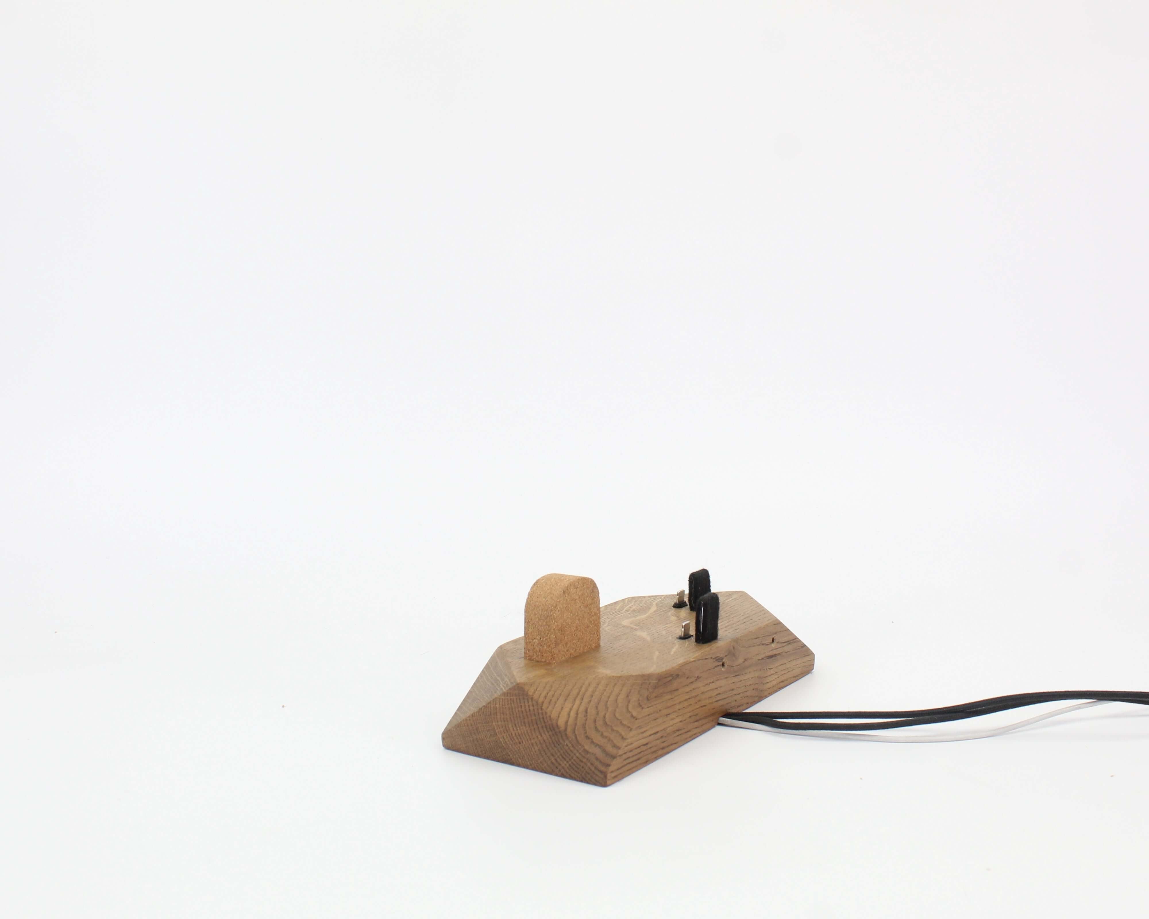 Triple Docking Station in brown oak, designed for two smartphones and an Apple Watch, enhancing workspace organization.