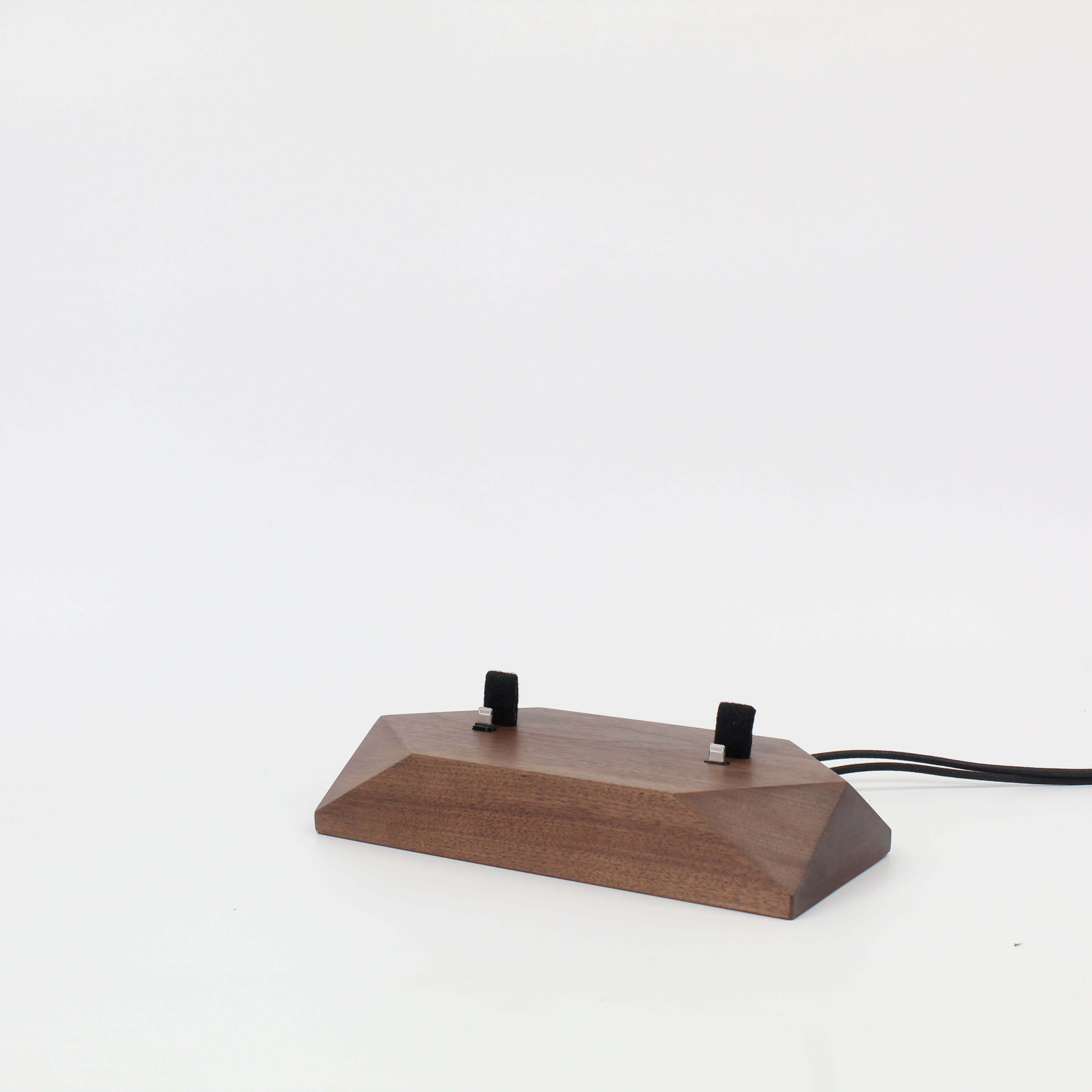 Dual phone dock in walnut wood, designed as a charging station for two devices, reducing cable clutter on your desk.