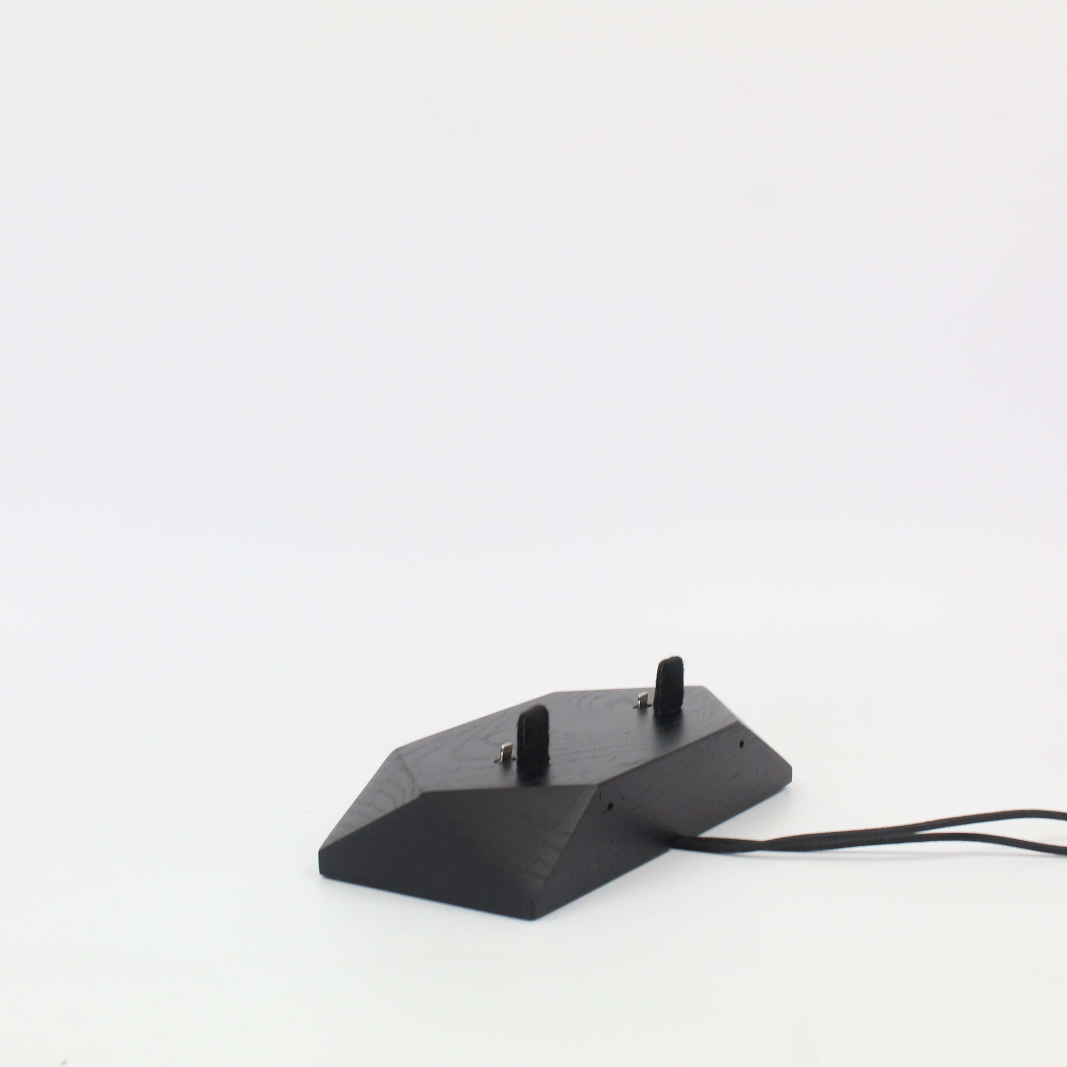 Dual phone dock in stained black oak design, featuring two charging ports for simultaneous device charging.