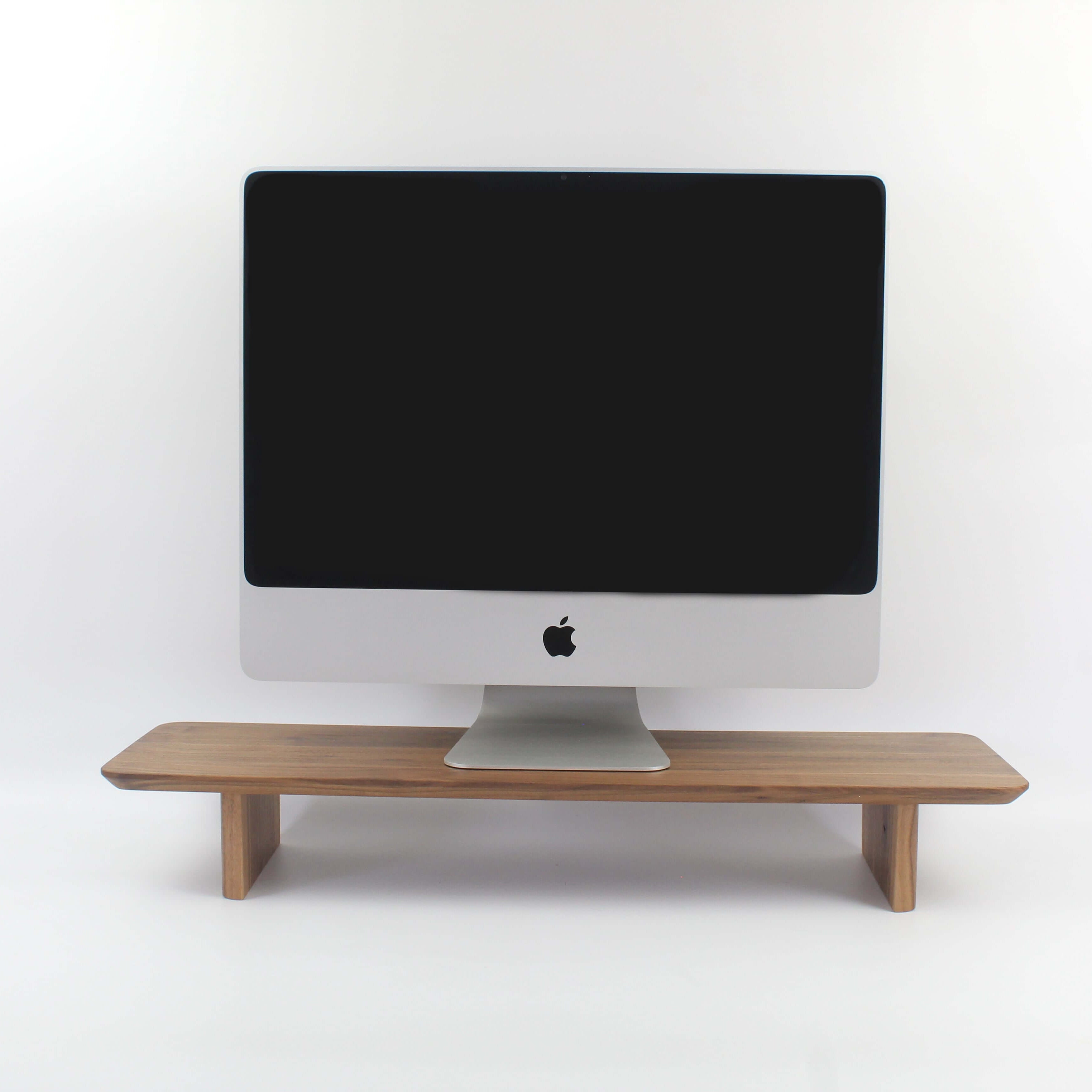 Wood monitor stand - walnut desk shelf for optimal workspace organization and ergonomic viewing.