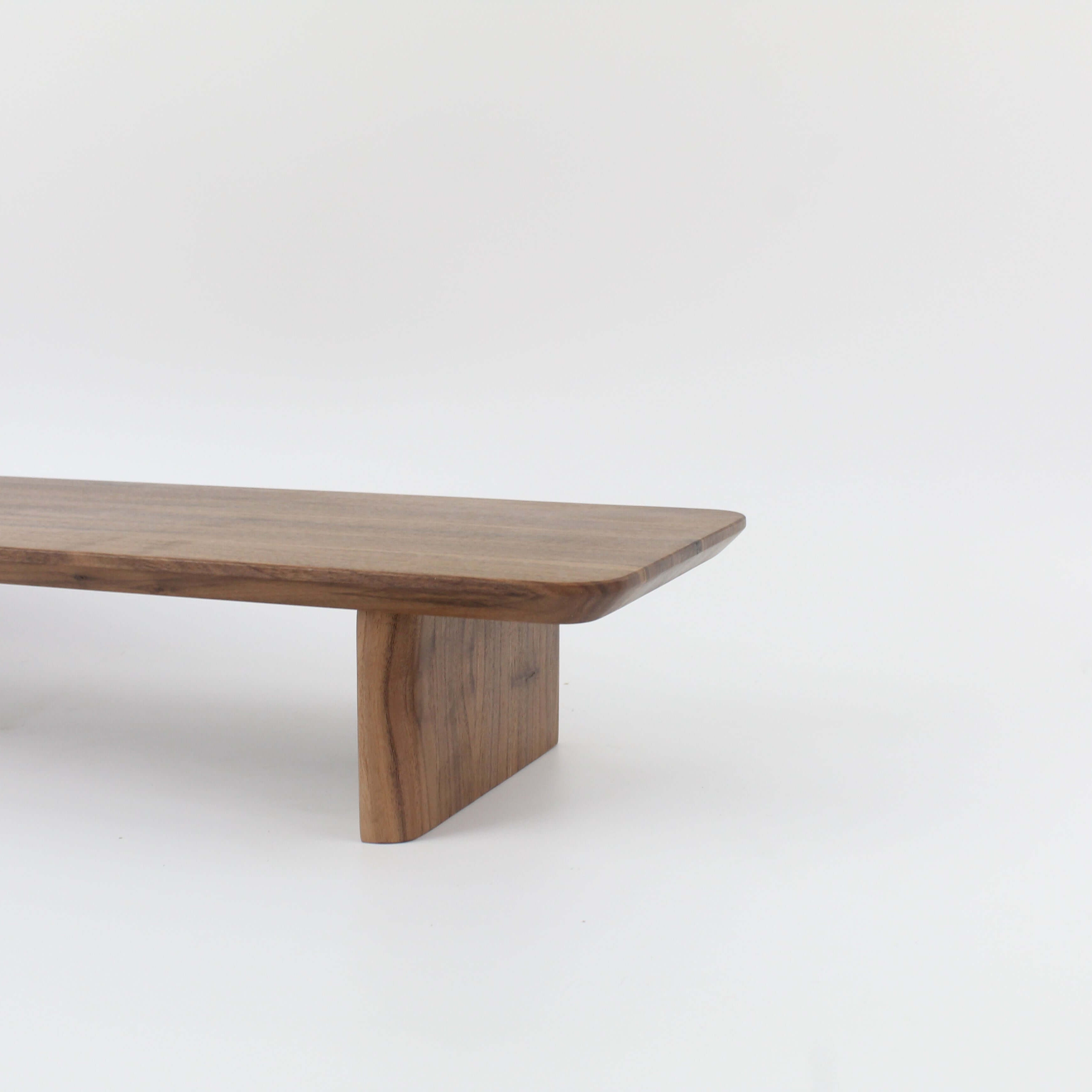 Desk Shelf in walnut wood, serving as a stylish monitor riser for workspace organization.