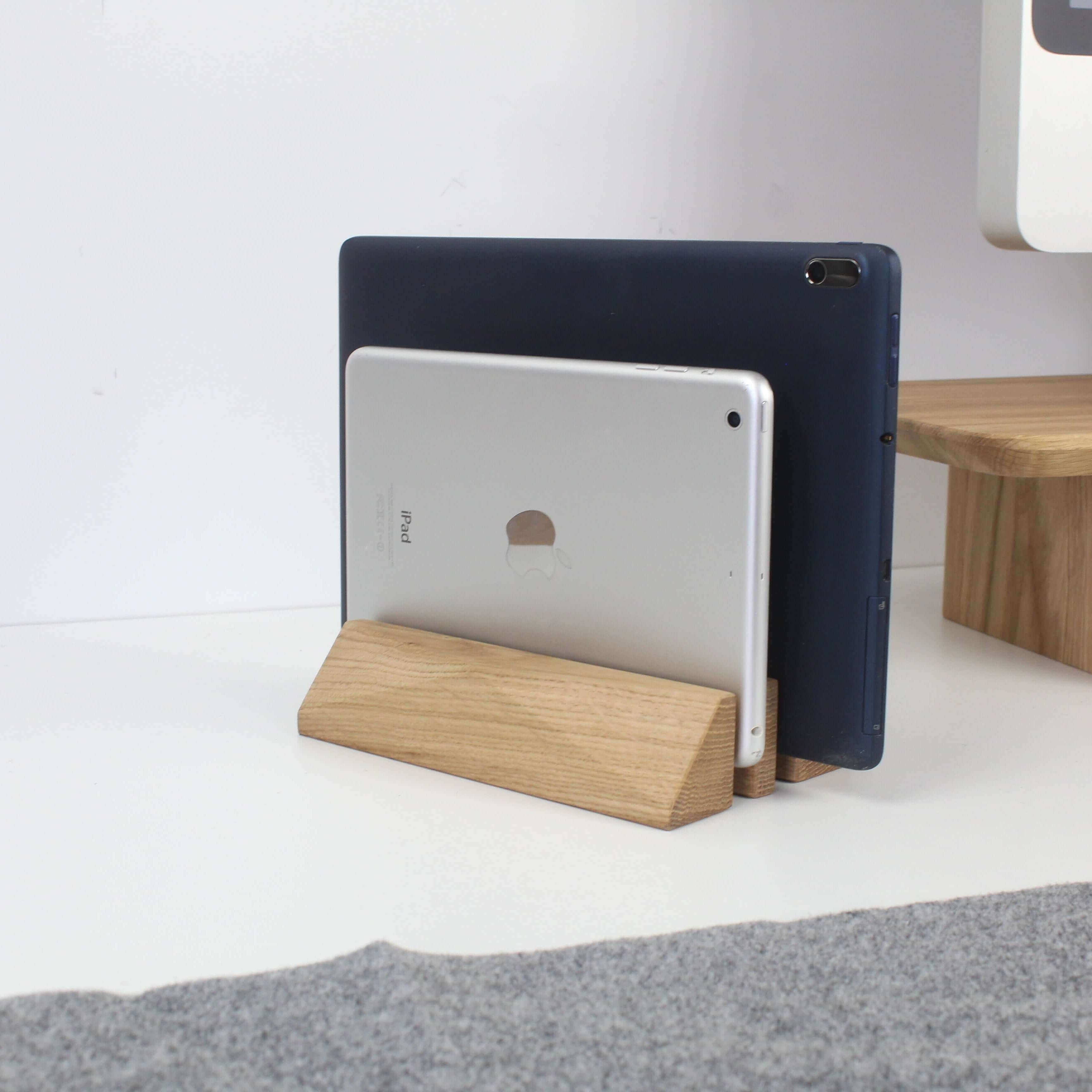 Dual laptop stand in oak showcasing two tablets neatly organized on a minimalist desk surface, enhancing workspace elegance.