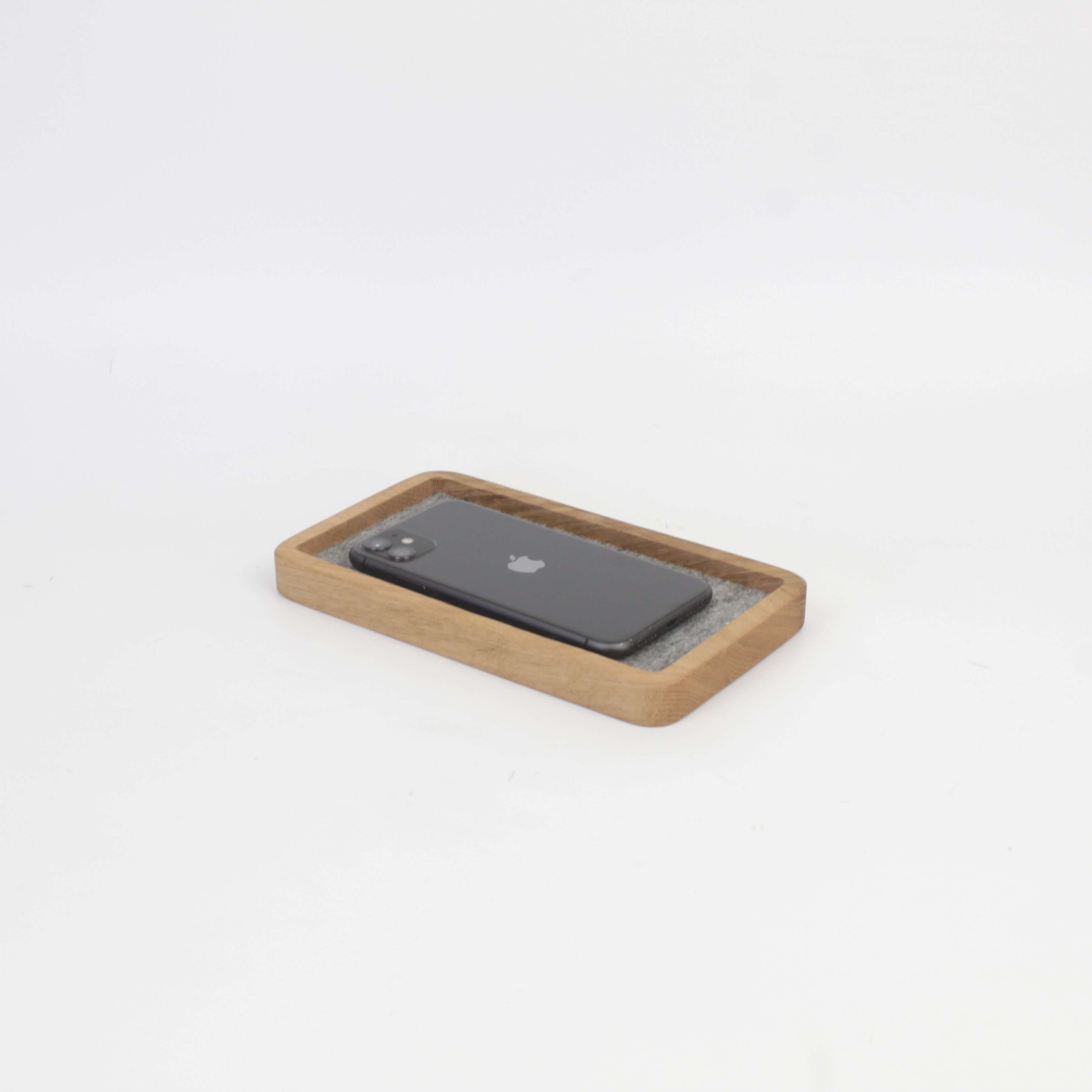 Catch All Tray in oak with a smartphone, ideal desk tray for organizing accessories and maintaining a tidy space.