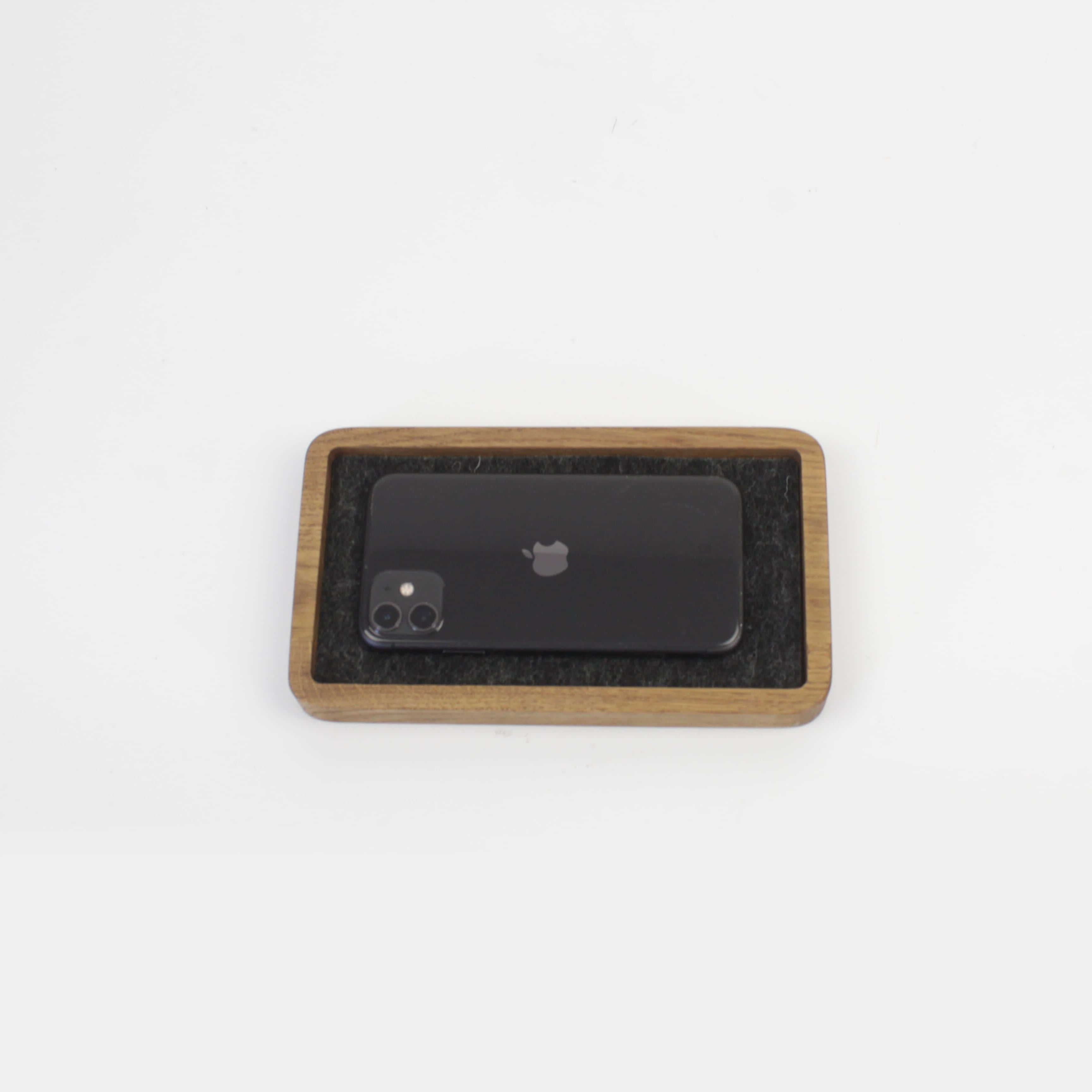 Brown oak desk tray holding a smartphone, perfect for organizing EDC and accessories.