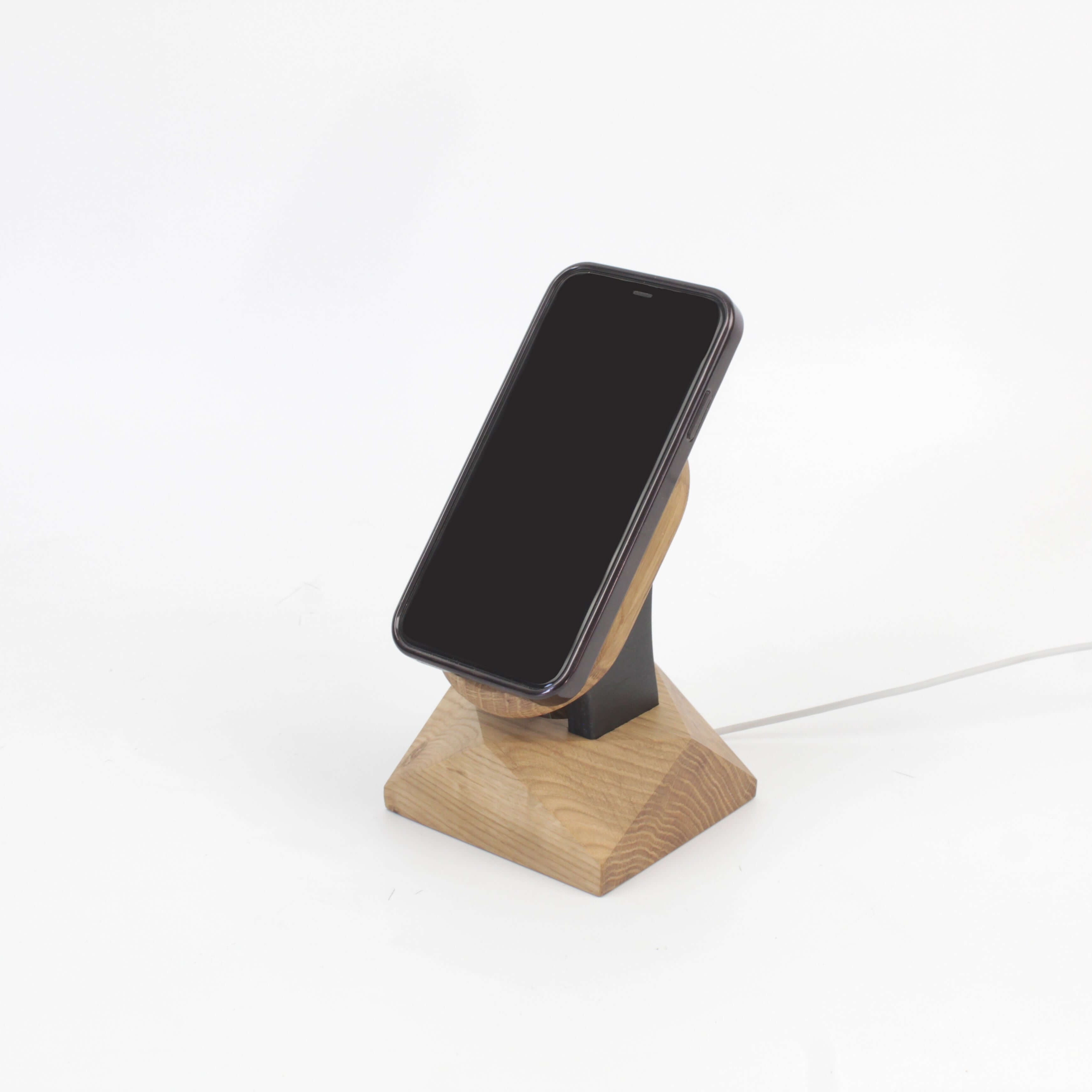 Handcrafted oak MagSafe iPhone stand, a stylish and minimalist wireless charger for your iPhone accessories.
