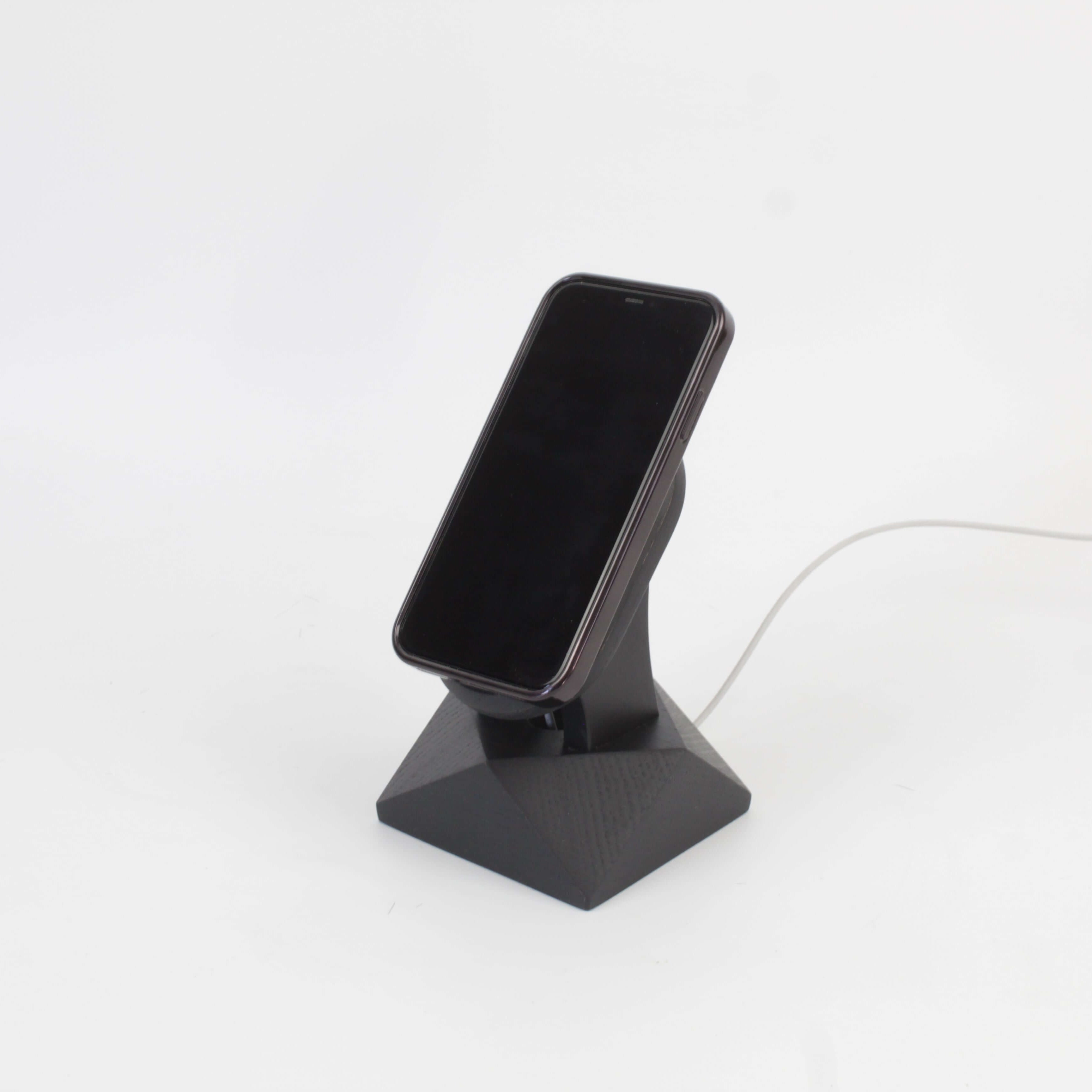 Handcrafted black oak MagSafe iPhone stand showcasing a sleek design for wireless charging and modern aesthetics.