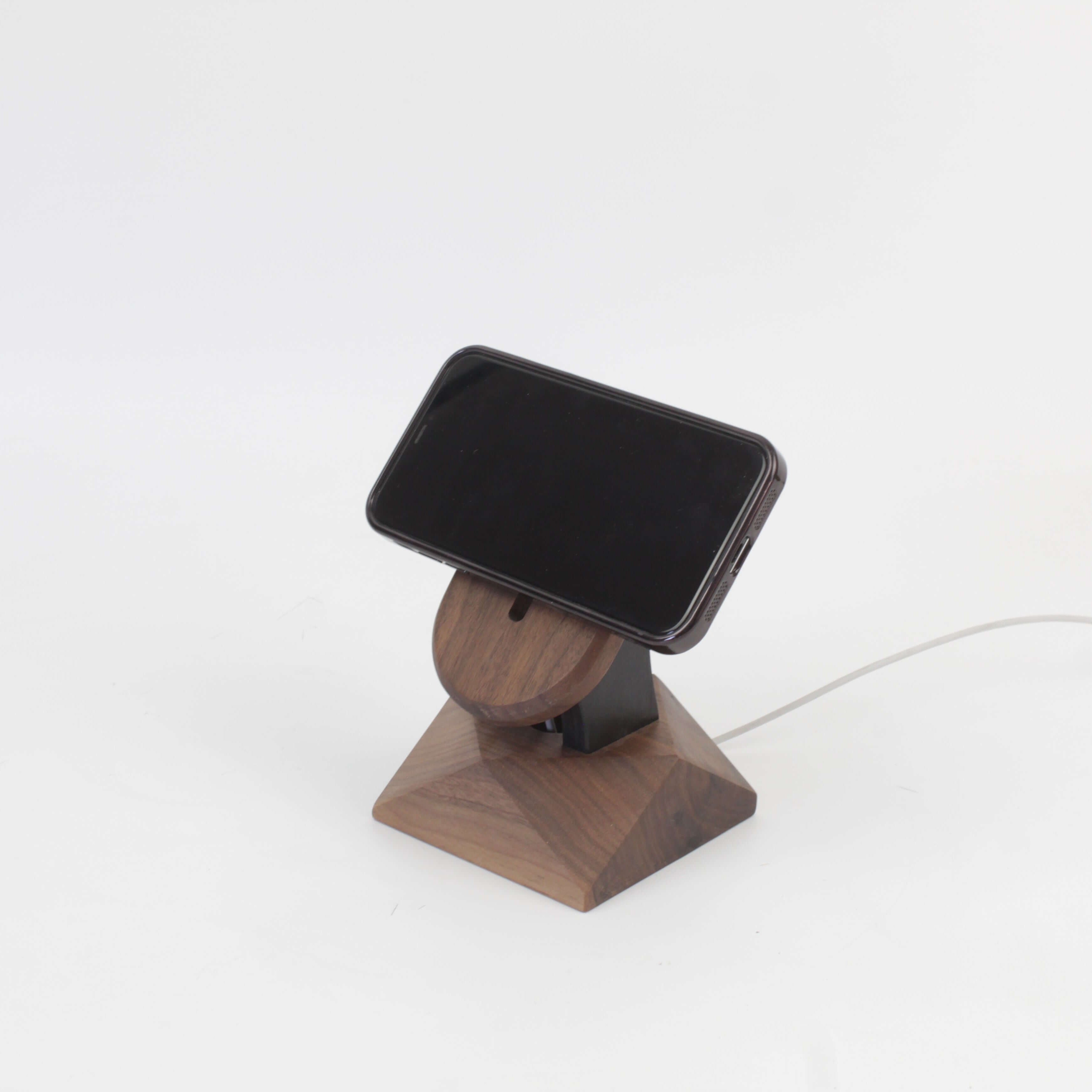 Handcrafted walnut MagSafe iPhone stand, featuring a minimalist design for wireless charging and modern iPhone accessories.