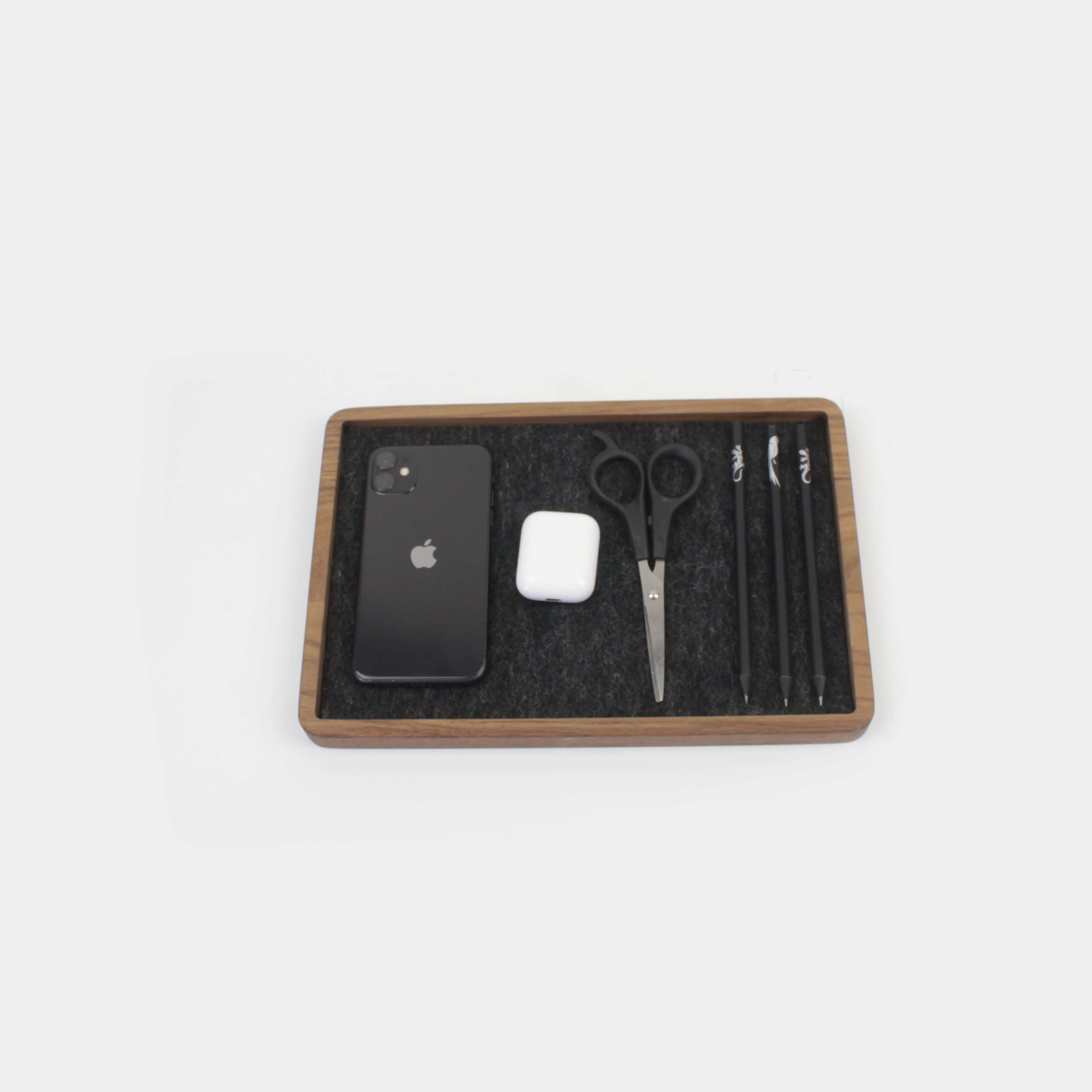 Catch All Tray in walnut with phone, AirPods, scissors, and pens for desk organization.