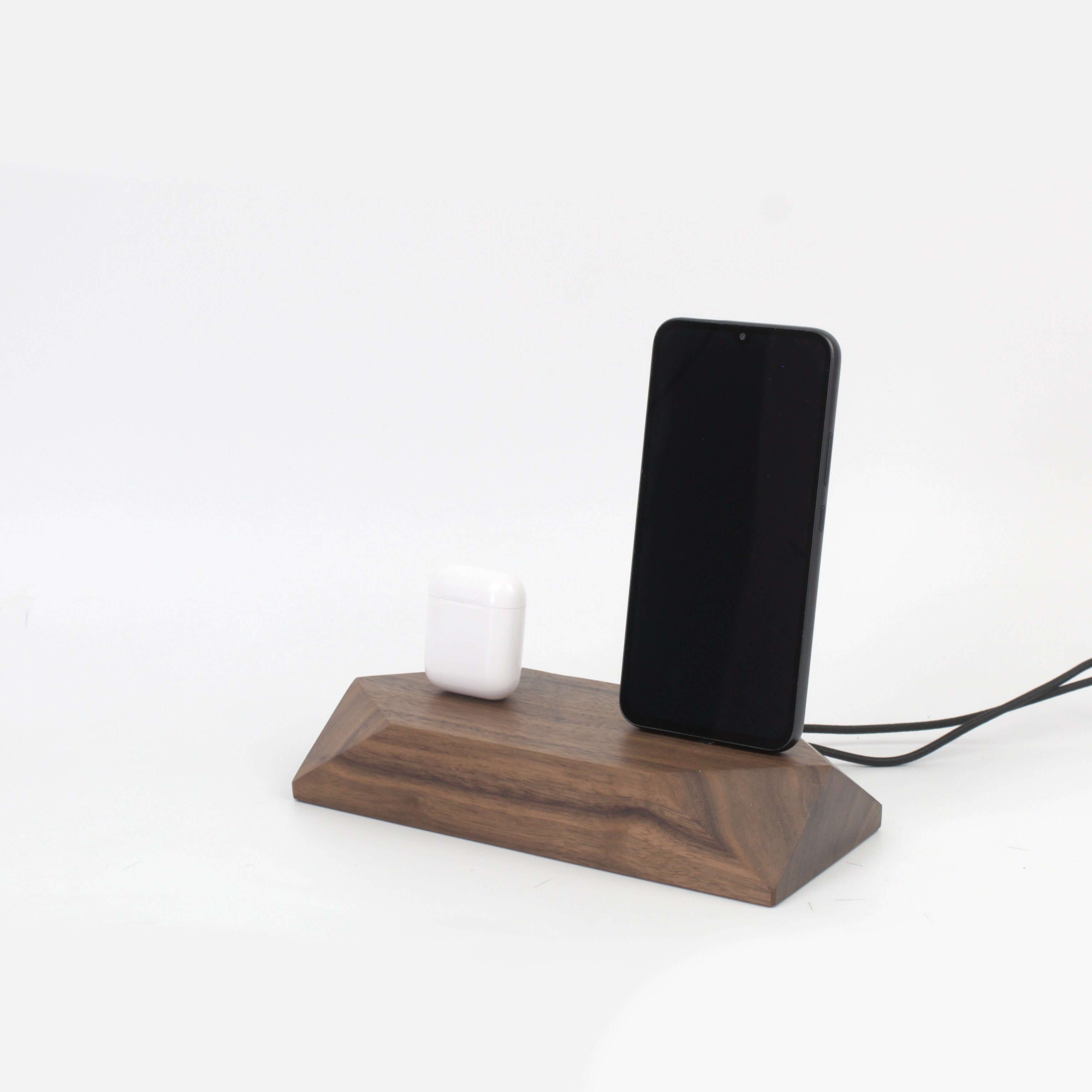 Dual charging station in walnut finish for phone and headphones, elegant desk organization solution.