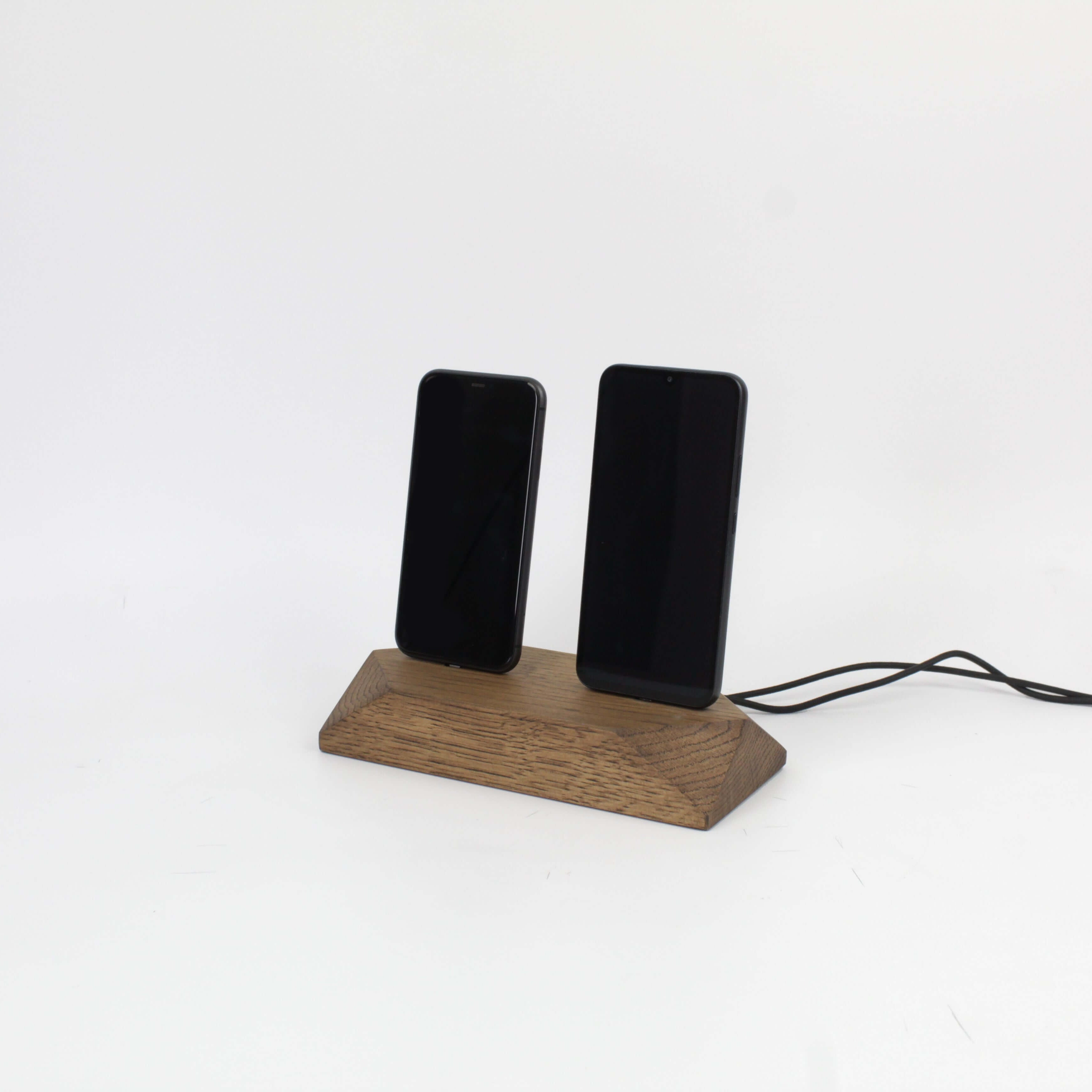 Dual phone dock in brown oak charging two devices simultaneously, ideal charging station for organized desks.