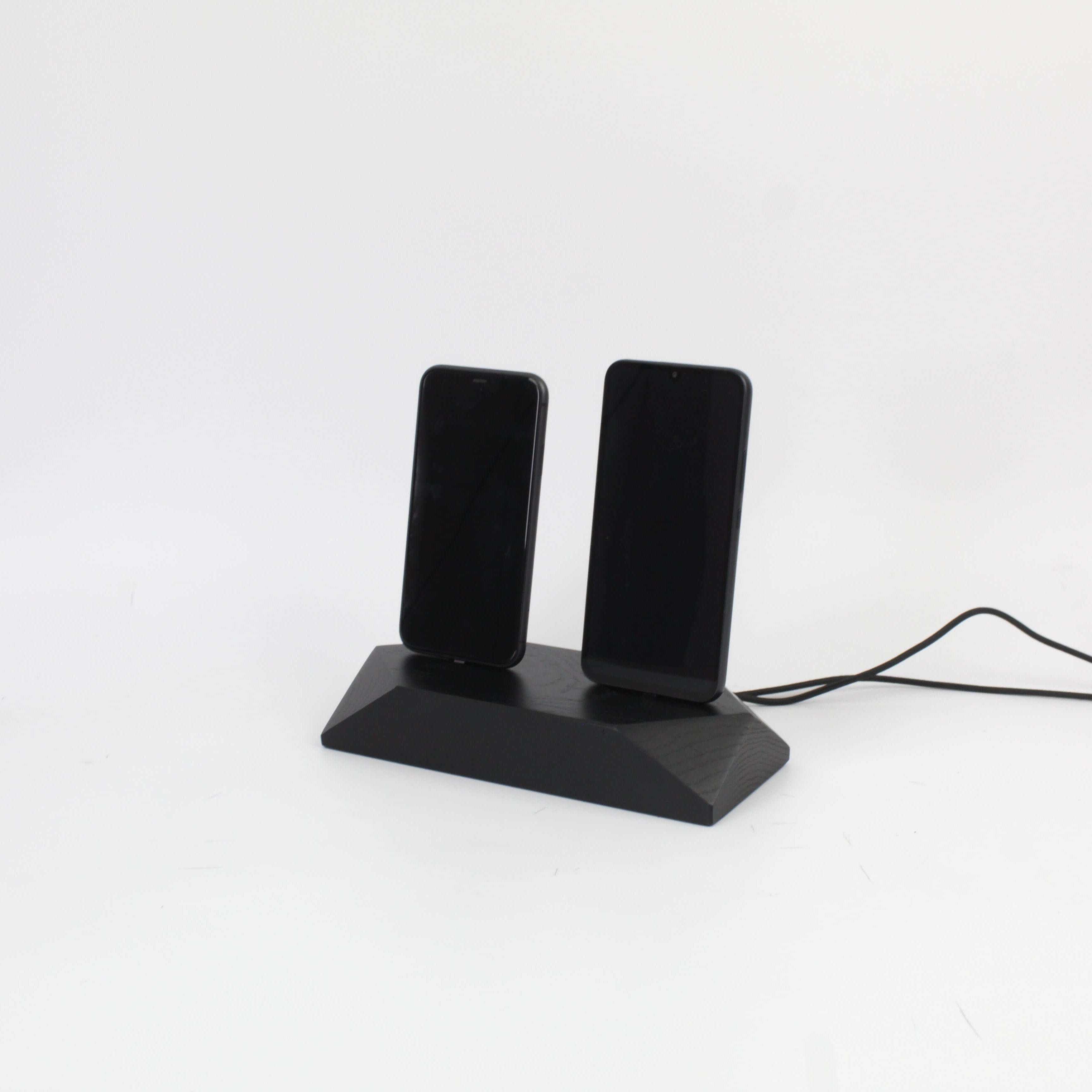 Dual Phone Dock in stained black oak for charging two devices simultaneously, reducing cable clutter on your desk.