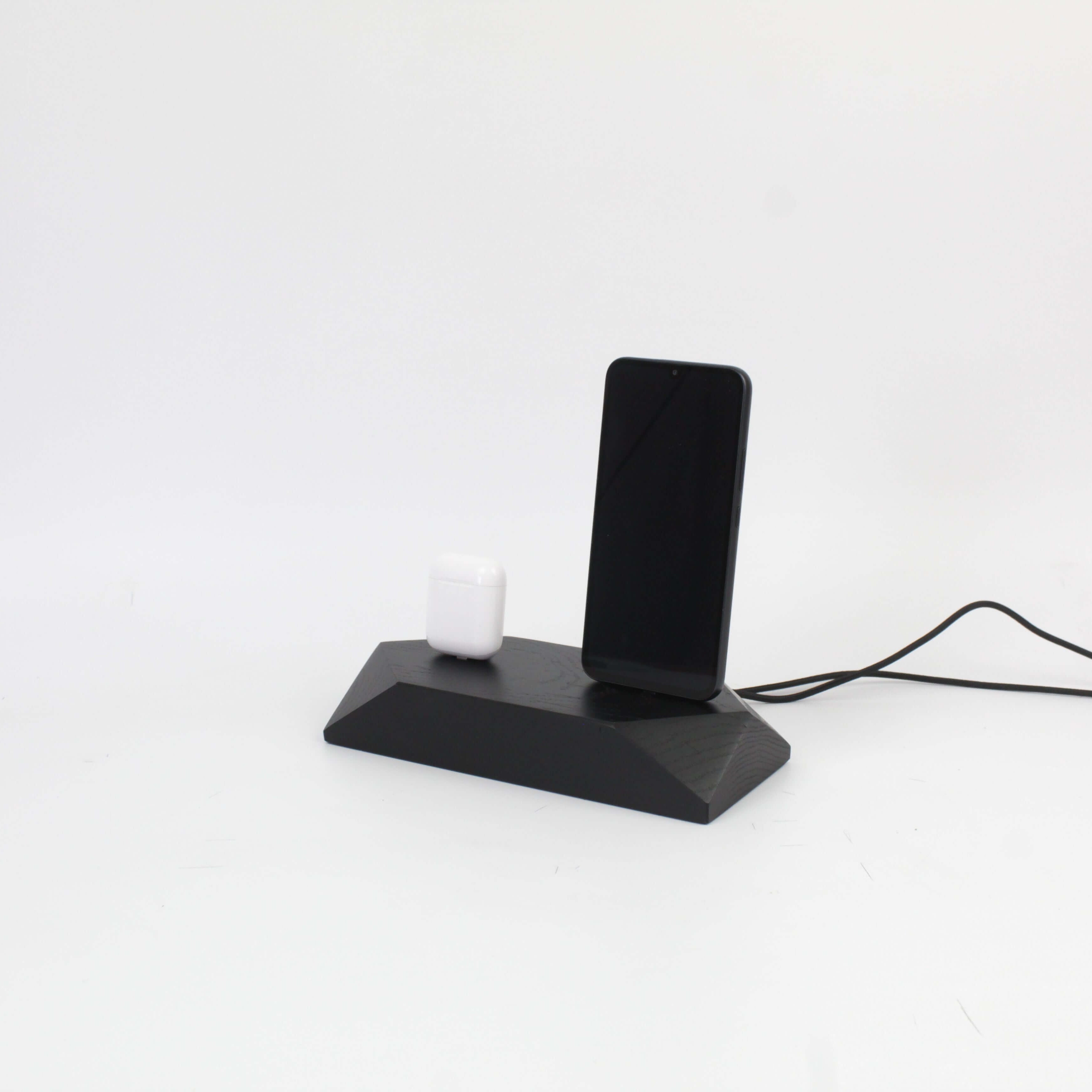 Dual Phone Dock in stained black oak charging an iPhone and AirPods, reducing desk clutter with a sleek design.