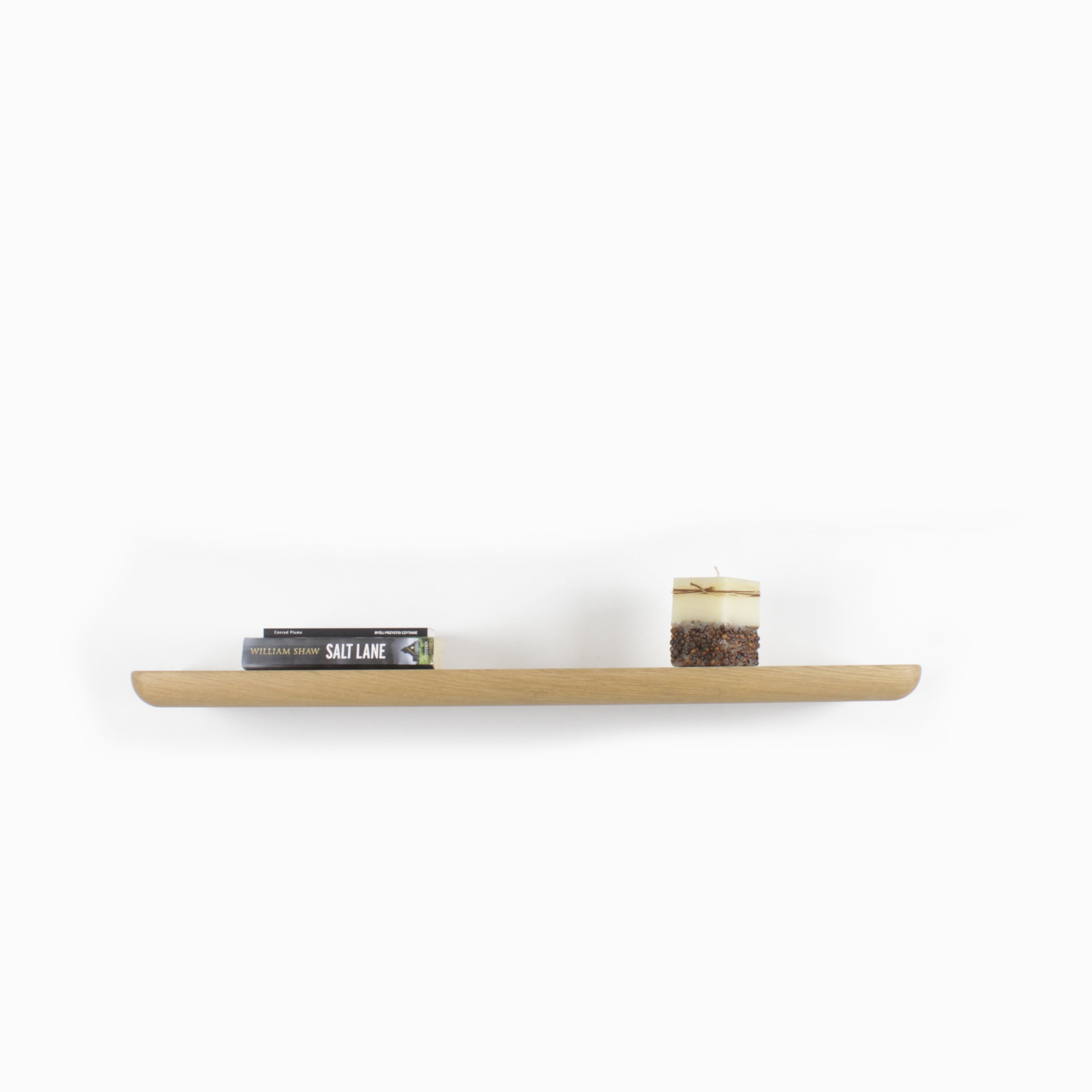 Wall Shelf - Oak: handcrafted floating shelf displaying books and a candle, perfect for modern home decor.
