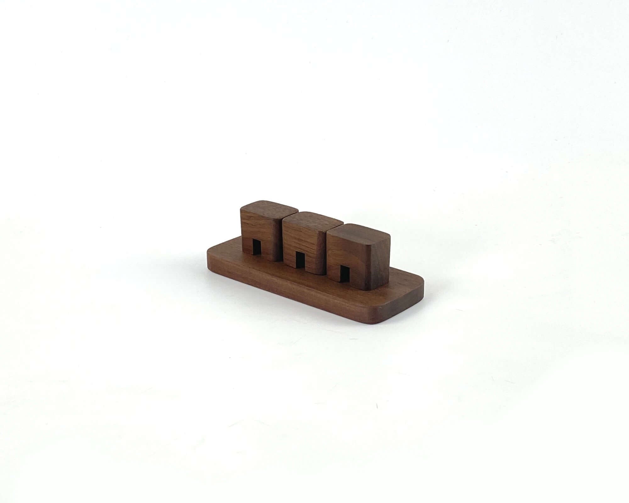 Cable Organizer - Walnut designed to keep cords neat and tidy on your desk with three slots for cables.