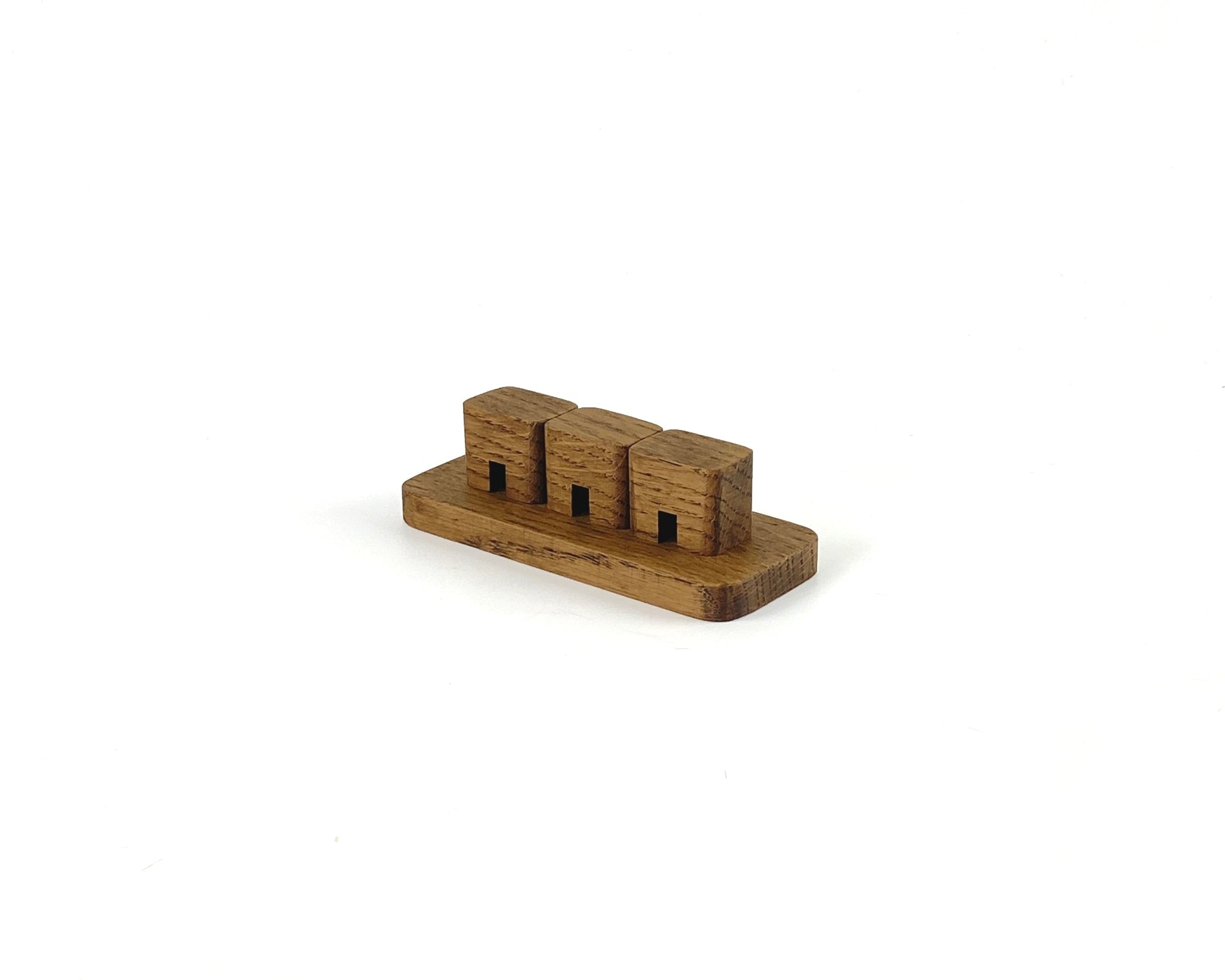 Brown Oak cable organizer designed to keep workspace tidy with three slots for managing cables.