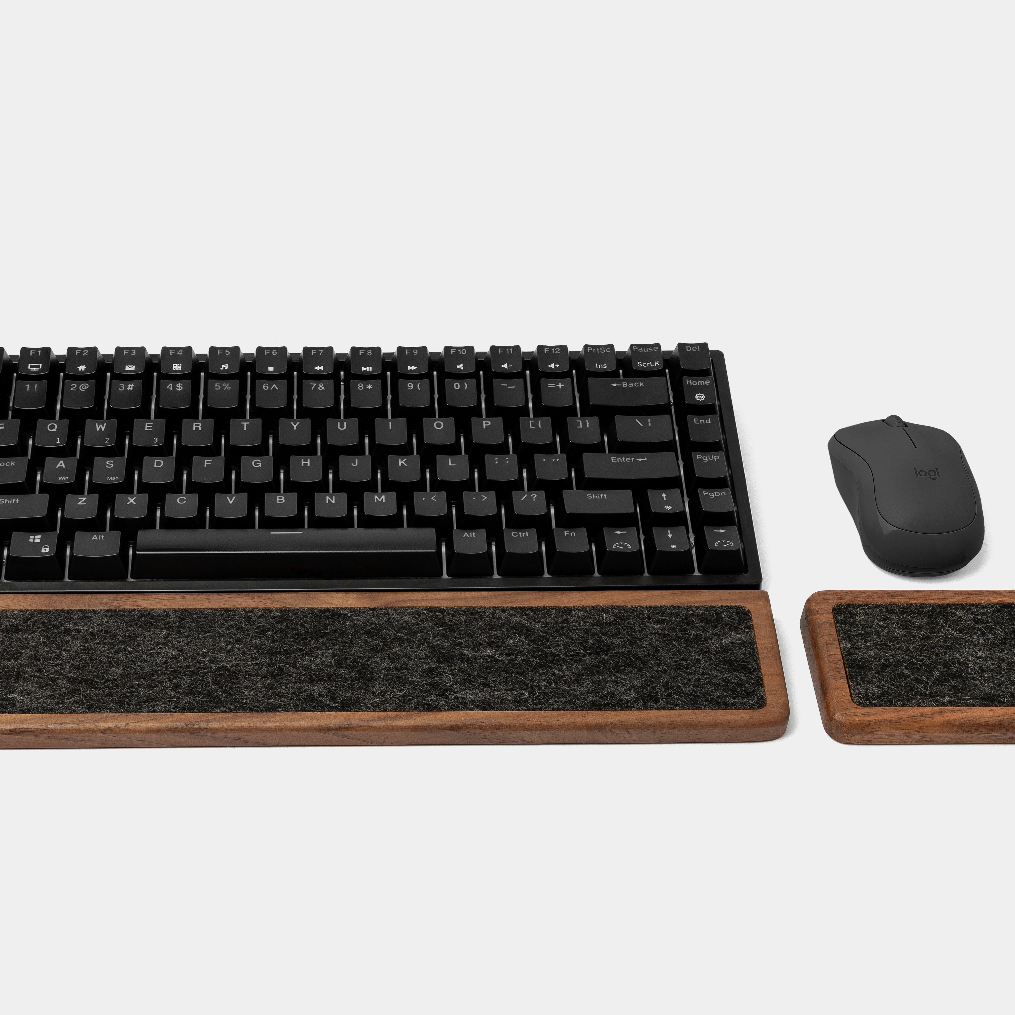 Keyboard wrist rest set in walnut color with matching mouse support for ergonomic workspace comfort.