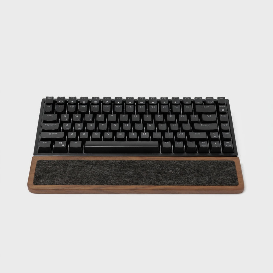 Keyboard Wrist Rest made of walnut wood with black mechanical keyboard on top, providing ergonomic support.