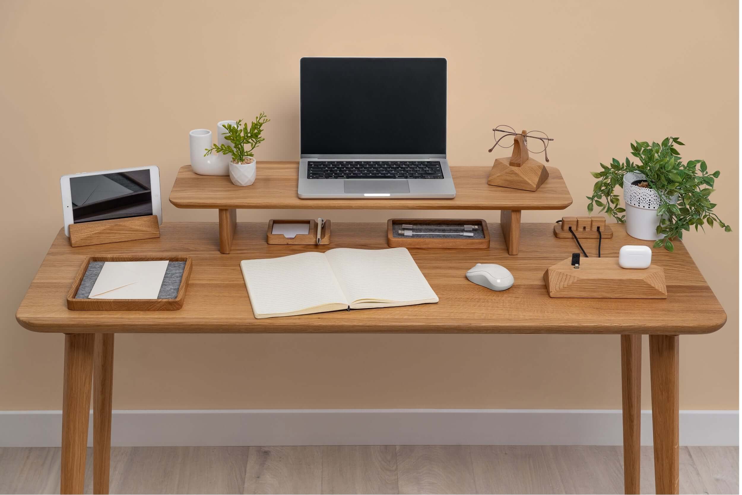 Wooden Table Top featuring a modern desk setup with laptop, plants, and stationery in a warm environment.
