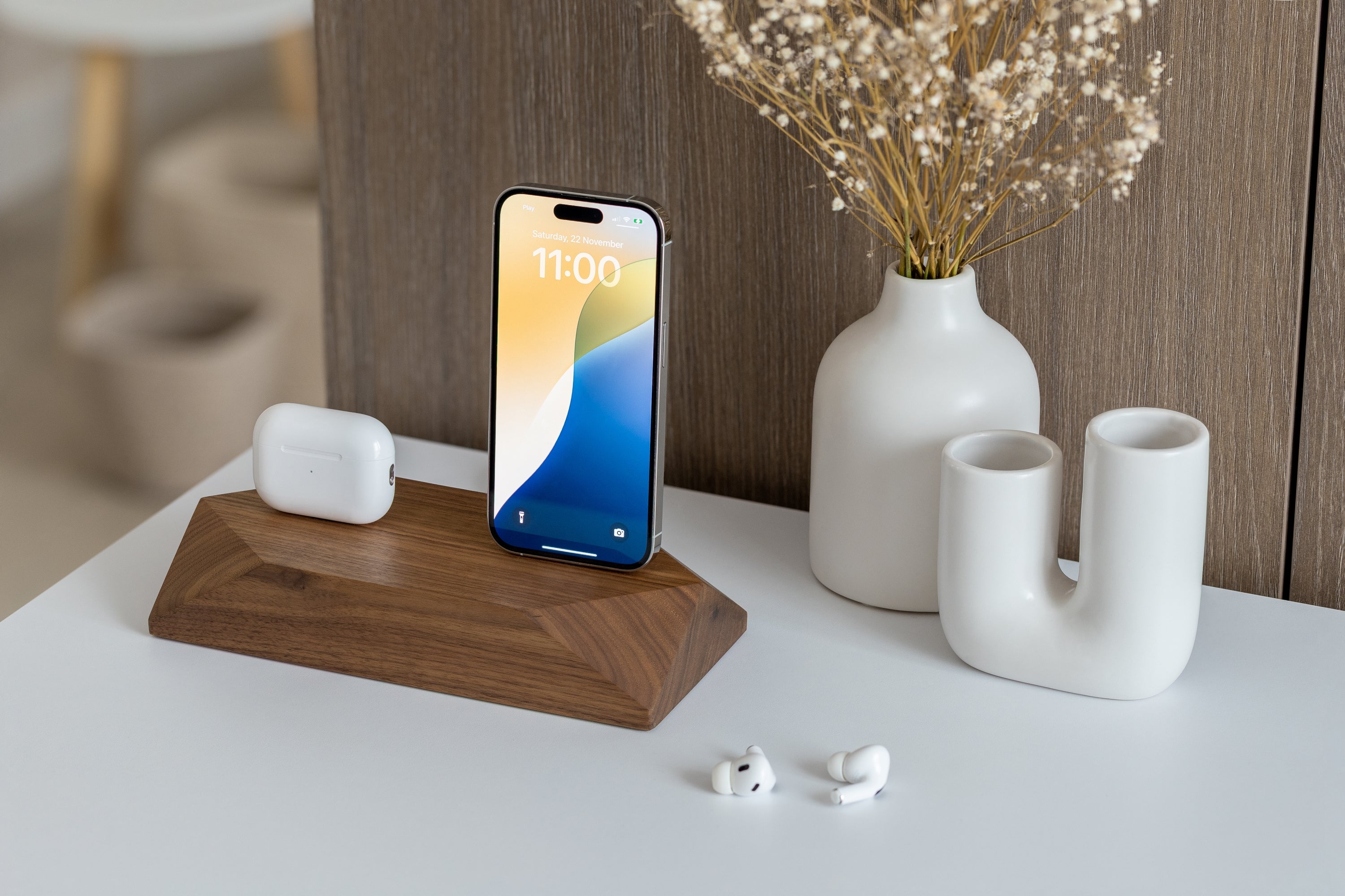 Dual Phone Dock - Walnut charging a phone and headphones, stylish wooden design, organized workspace.