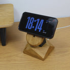 MagSafe iPhone stand made from oak wood, showcasing a wireless charger with a sleek design and time display.