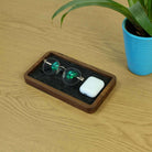 Walnut desk tray holding sunglasses and AirPods, enhancing organization and style in a tidy space.