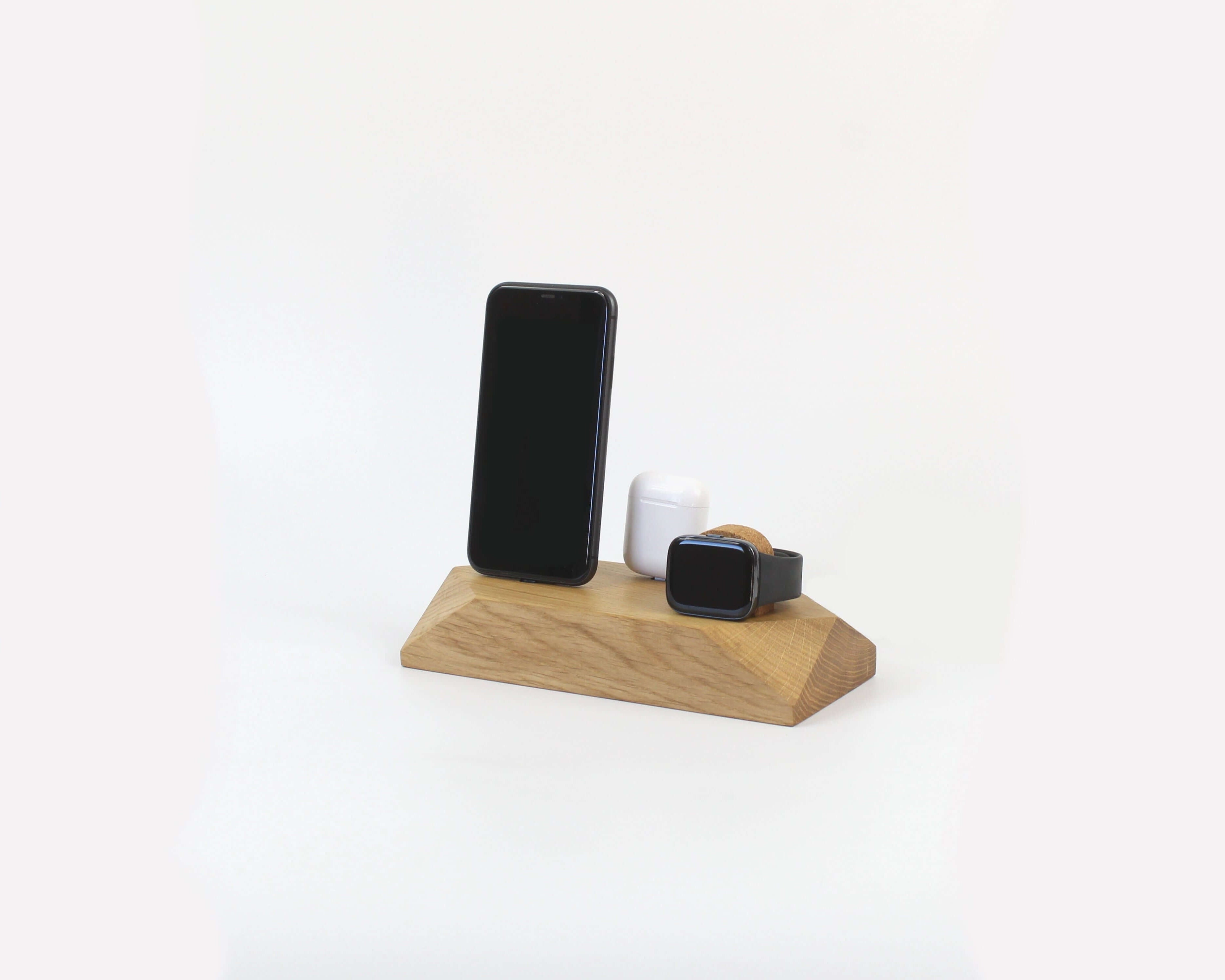 Triple Phone Dock - Oak with two smartphones and an Apple Watch on a stylish wooden base.