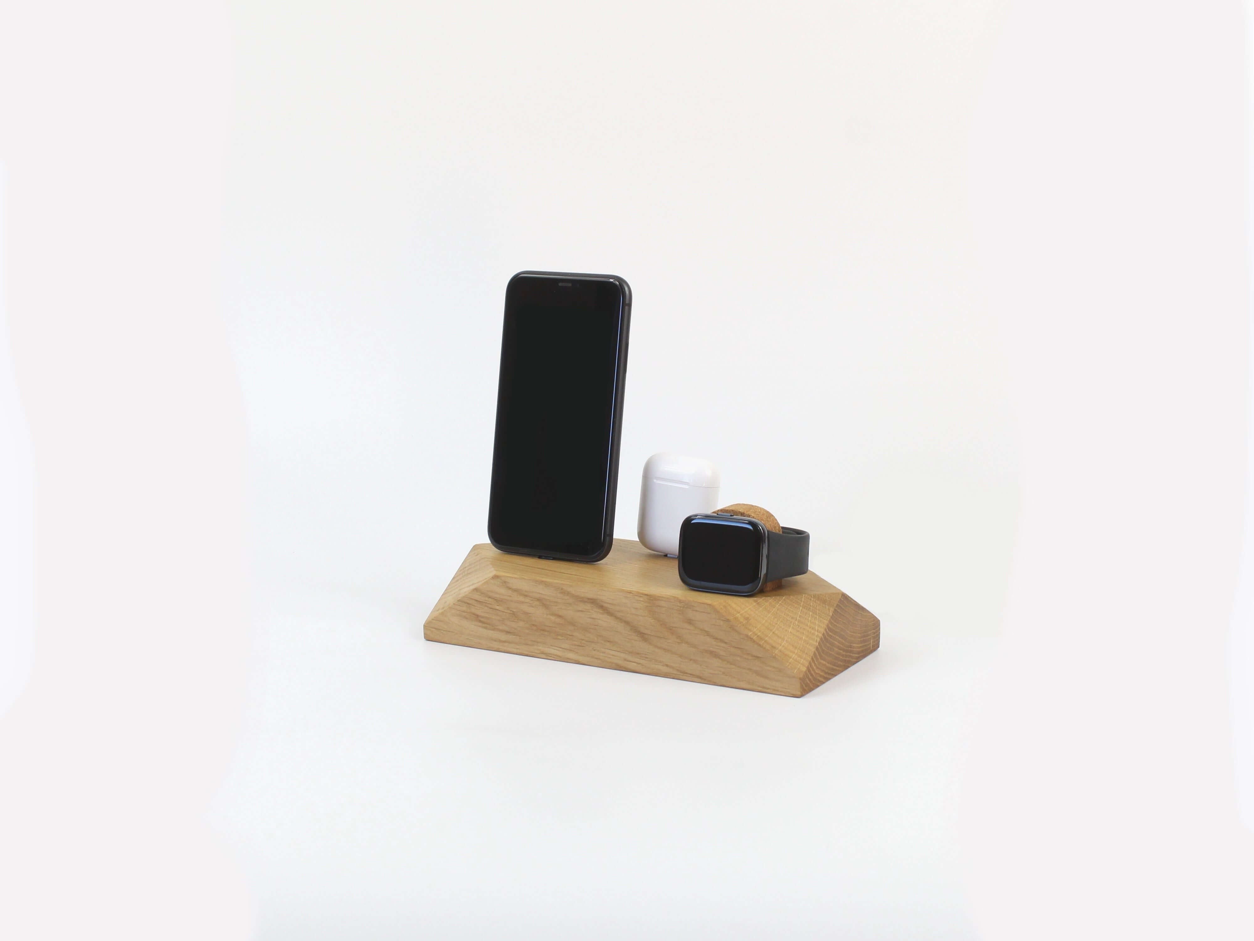 Triple Docking Station in oak, holding two smartphones and an Apple Watch, a sleek 3-in-1 charging solution for phone accessories.