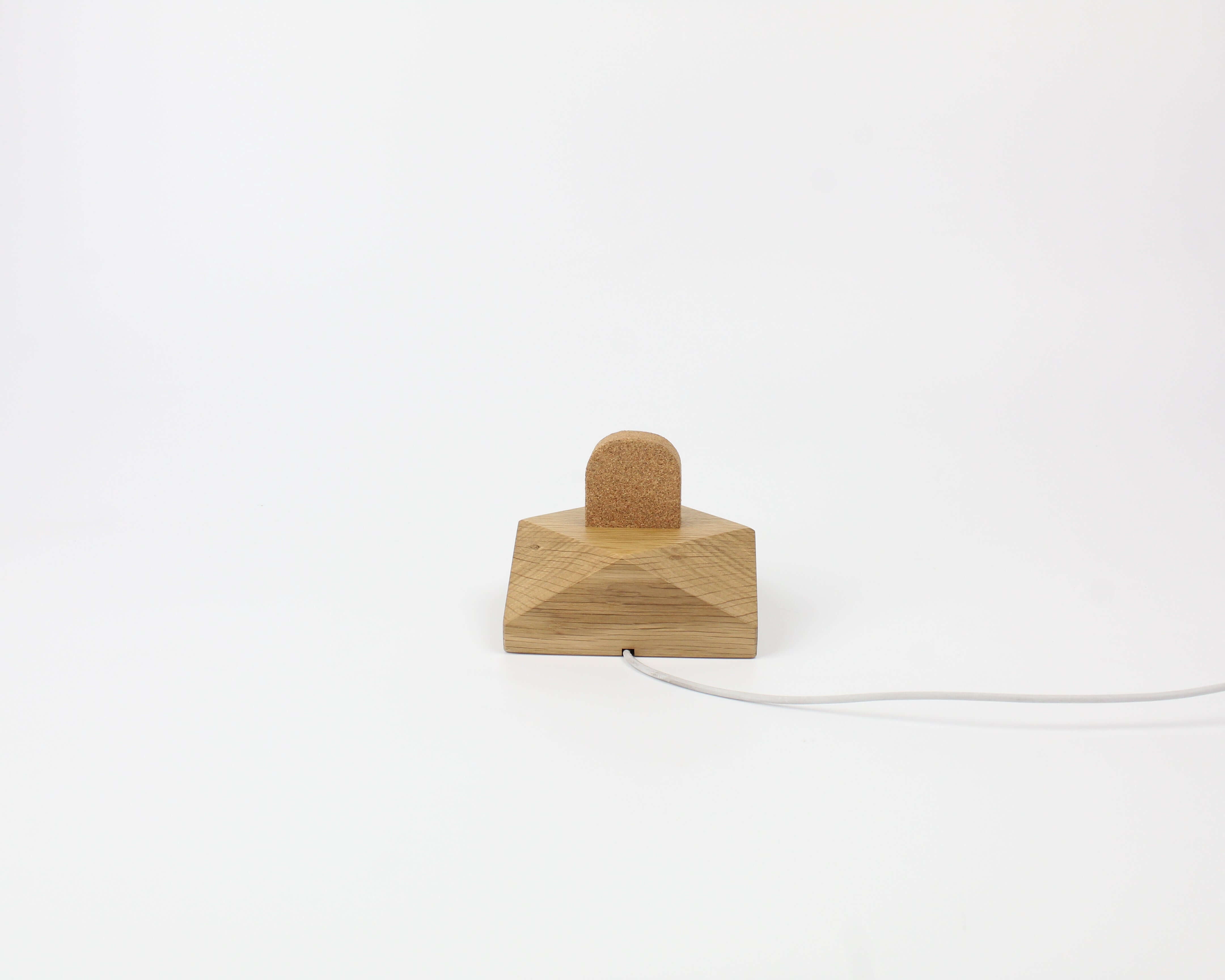 Apple Watch charging stand in oak wood, stylish design for desk organization and easy charging.