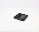 Black oak square catch all desk tray holding a phone and pens, ideal for organizing desk accessories.