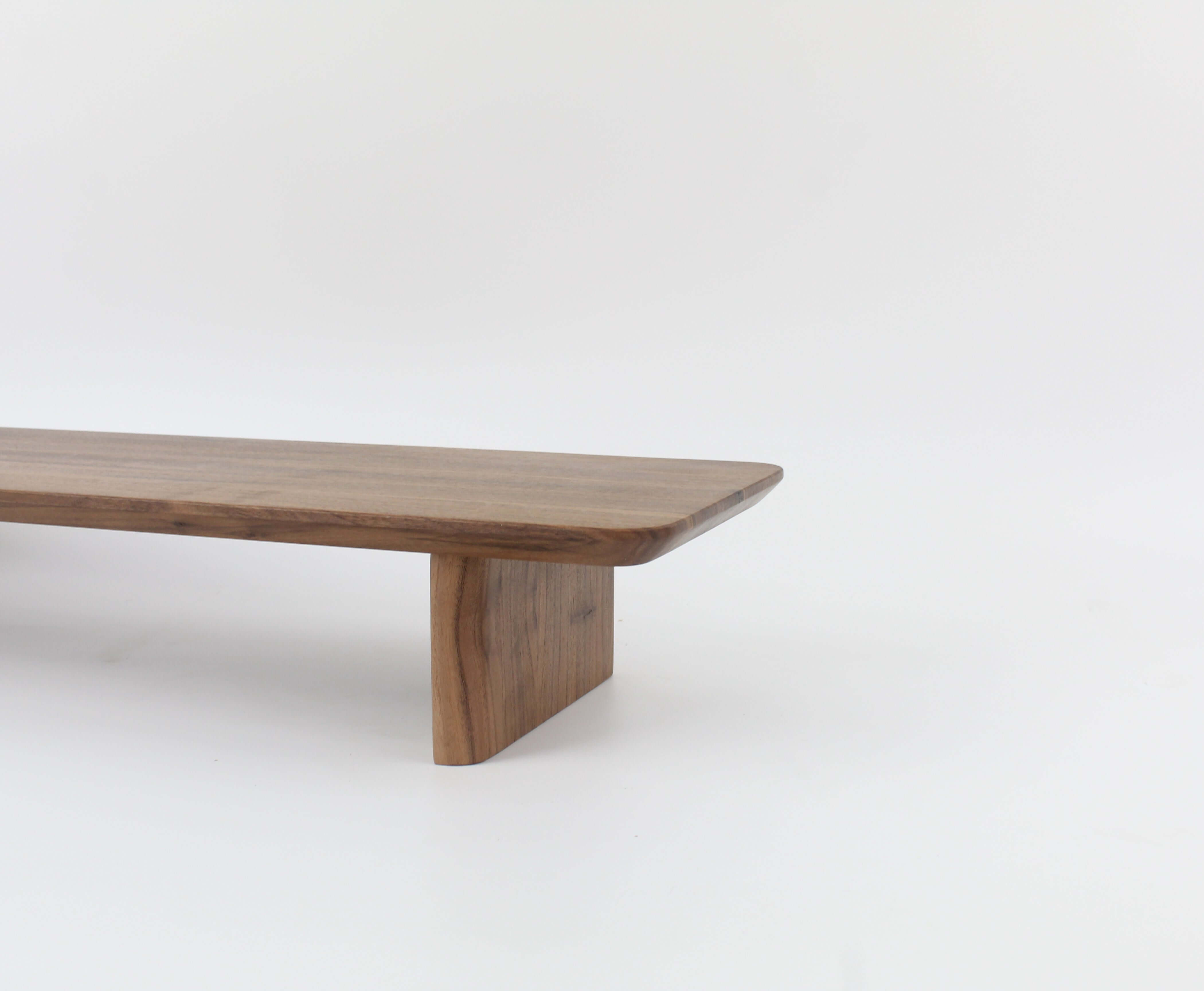 Desk Shelf in walnut wood, serving as a stylish monitor riser for workspace organization.