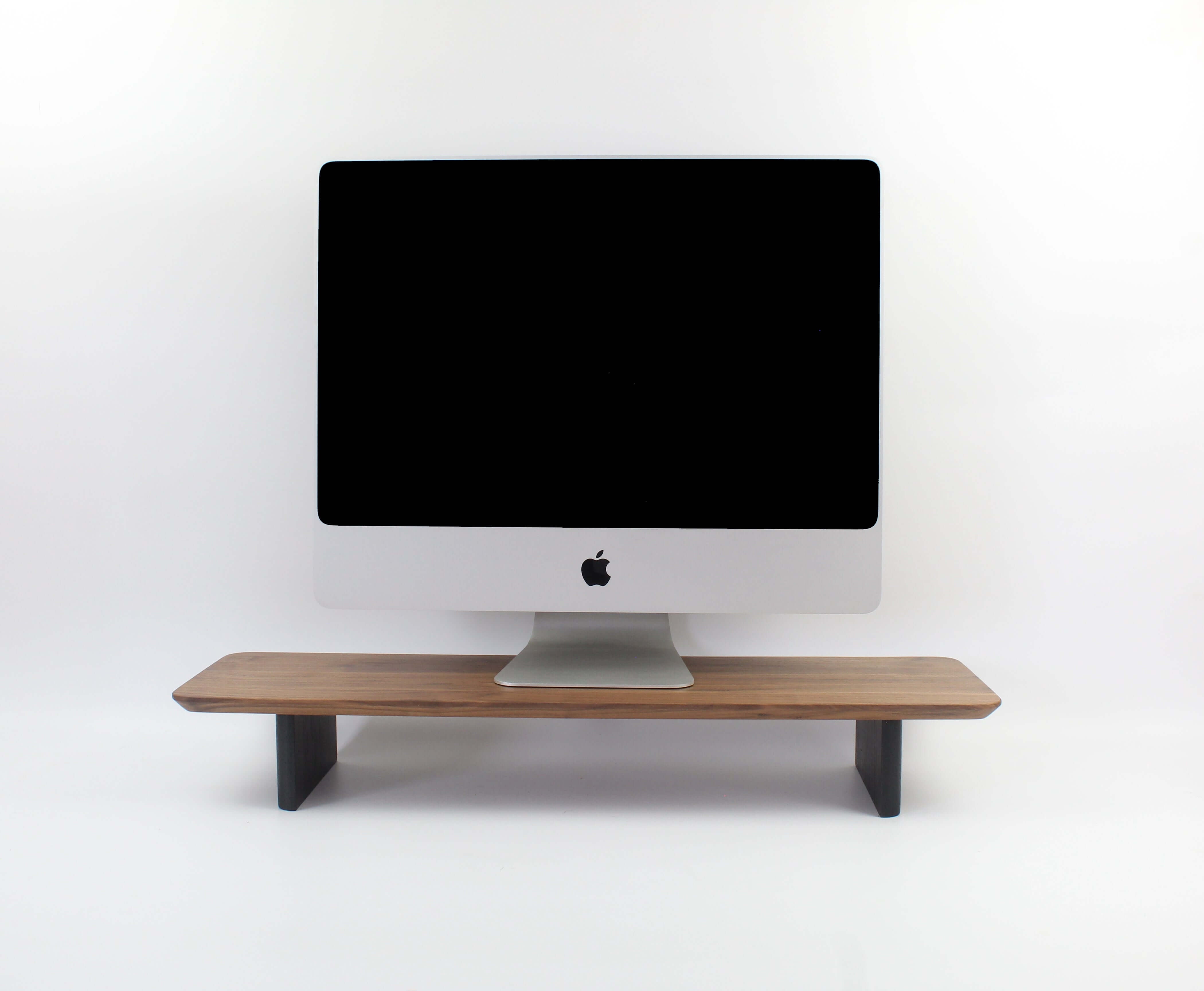 Walnut desk shelf monitor riser enhancing workspace organization and aesthetics.