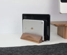 Dual laptop stand in walnut wood, neatly holding two devices on a minimalist desk for organized workspace.