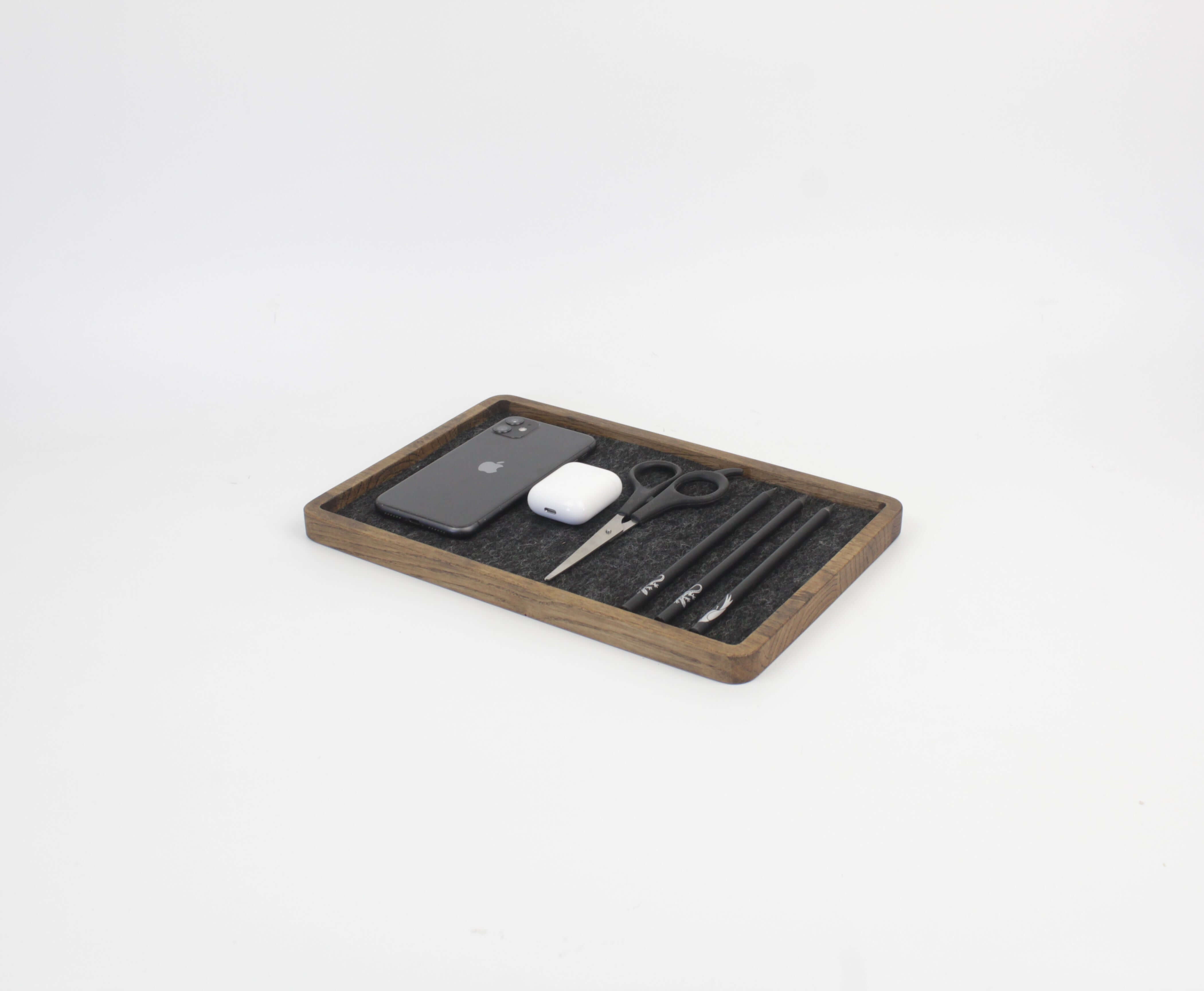 Catch All Tray in brown oak holding a phone, AirPods, scissors, and pens for organized living.