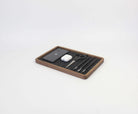 Walnut catch all tray holding a phone, AirPods, scissors, and pens, perfect for desk organization.