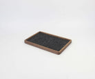 Walnut catch all tray with felt surface, ideal for organizing gadgets and accessories on desk or nightstand.