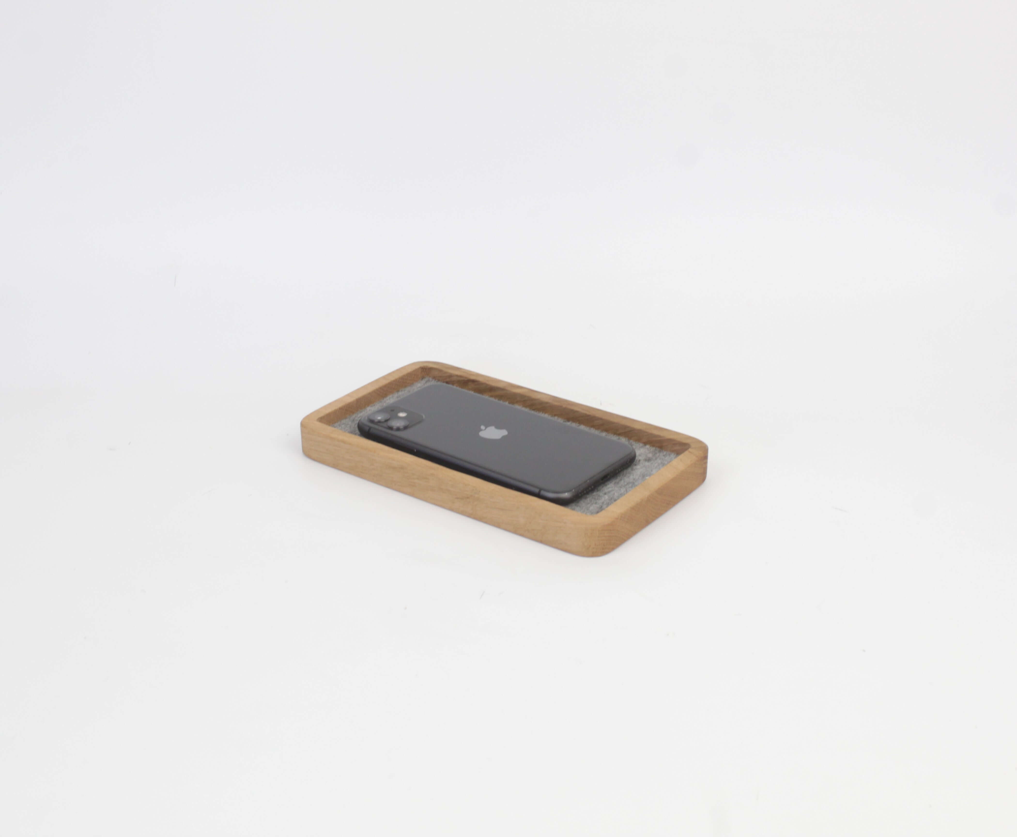 Catch All Tray in oak with a smartphone, ideal desk tray for organizing accessories and maintaining a tidy space.