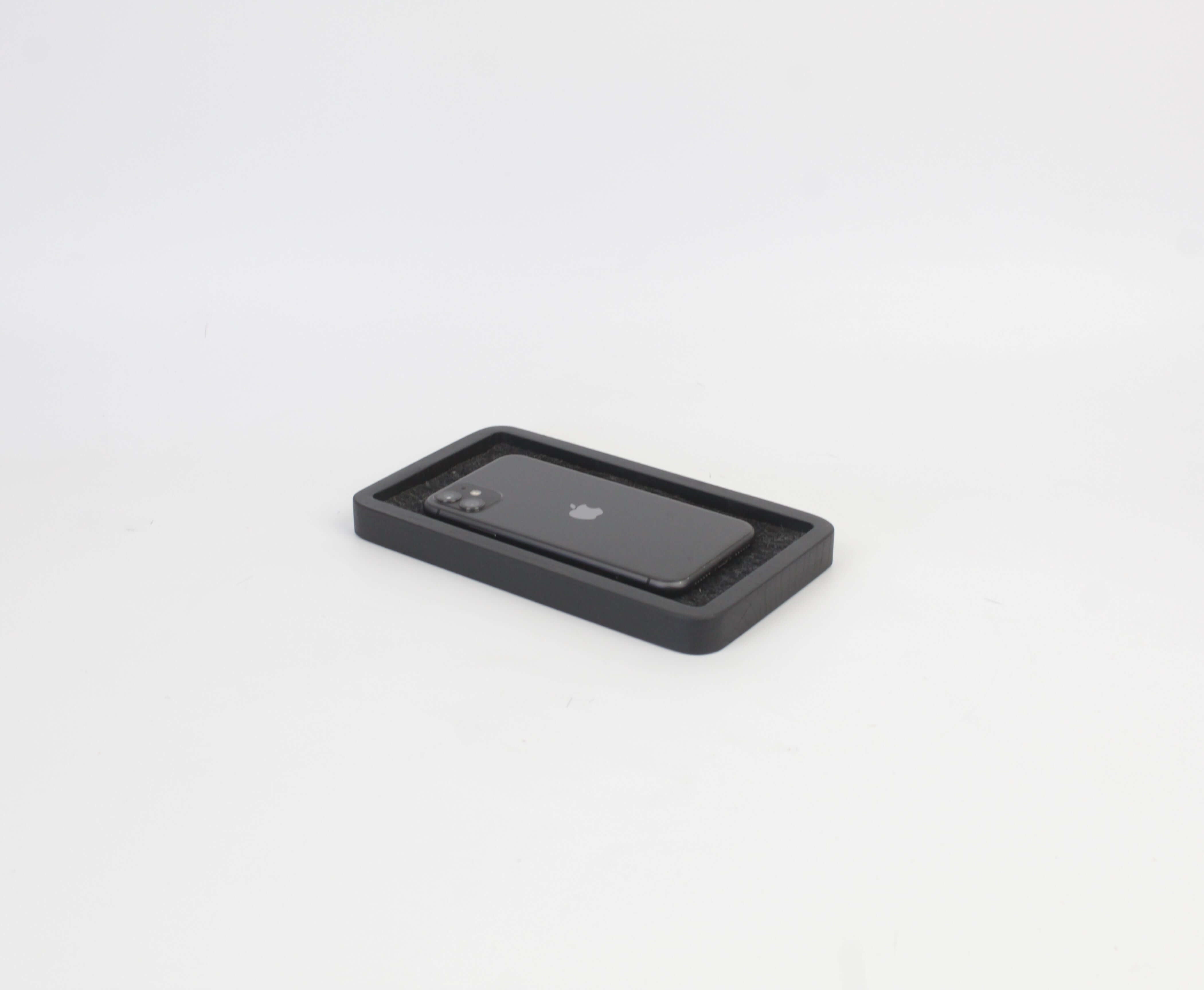 Catch All Tray in black oak with smartphone, perfect for organization and style on desk or nightstand.