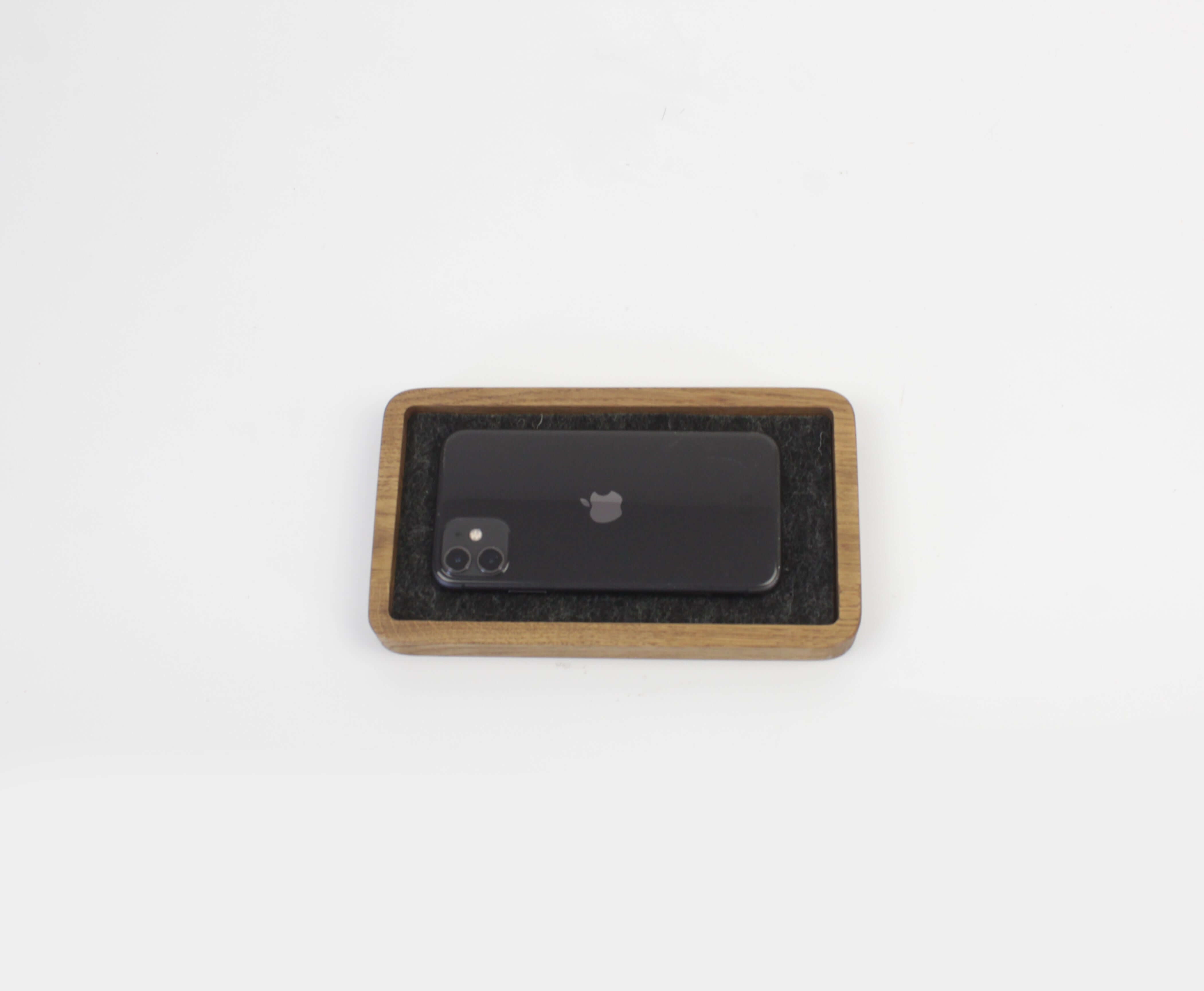 Brown oak desk tray holding a smartphone, perfect for organizing EDC and accessories.