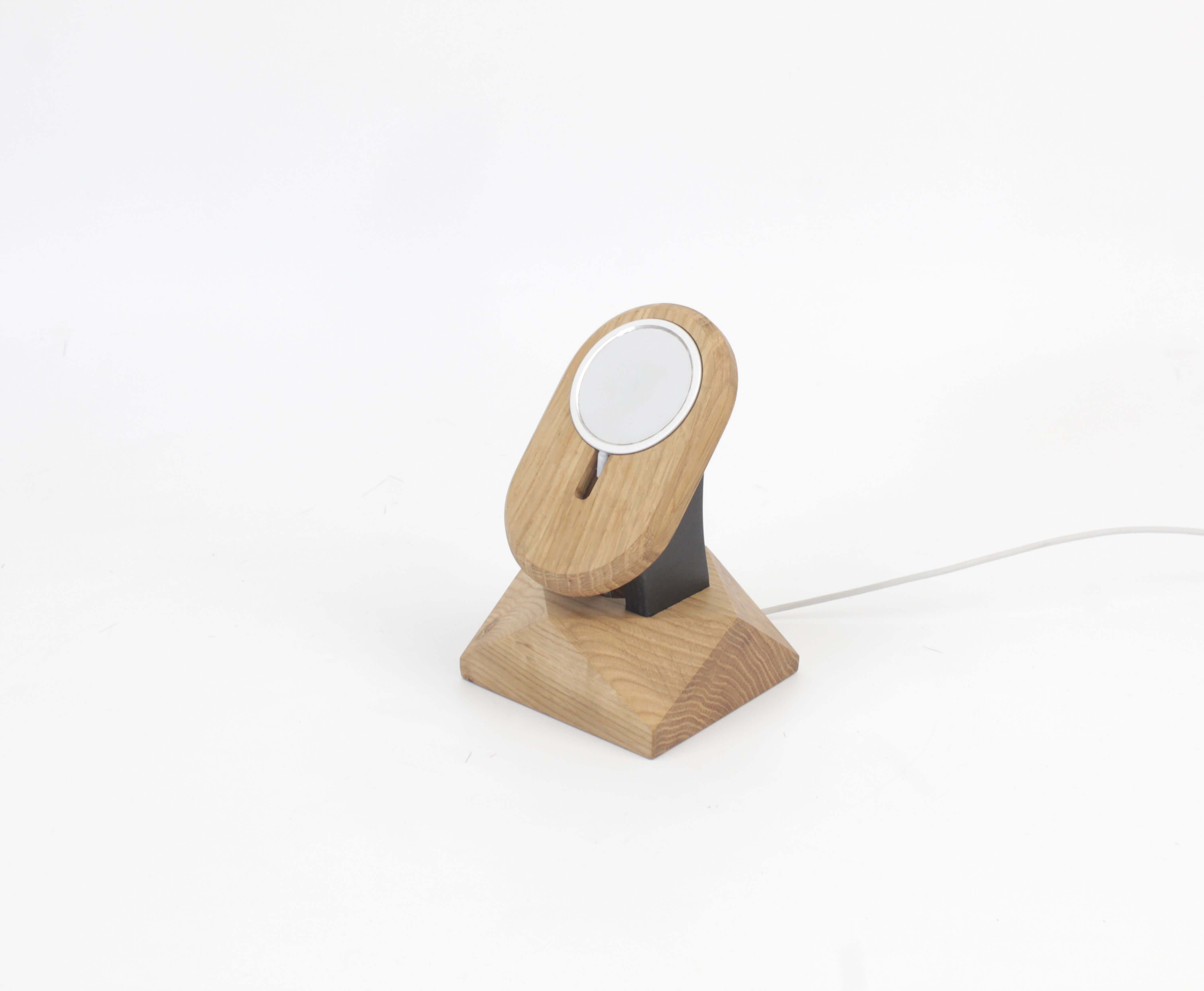 Handcrafted oak MagSafe iPhone stand serving as a stylish iPhone wireless charger and accessory.