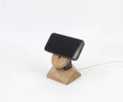 Handcrafted oak MagSafe iPhone stand serving as a minimalist wireless charger and stylish iPhone accessory.