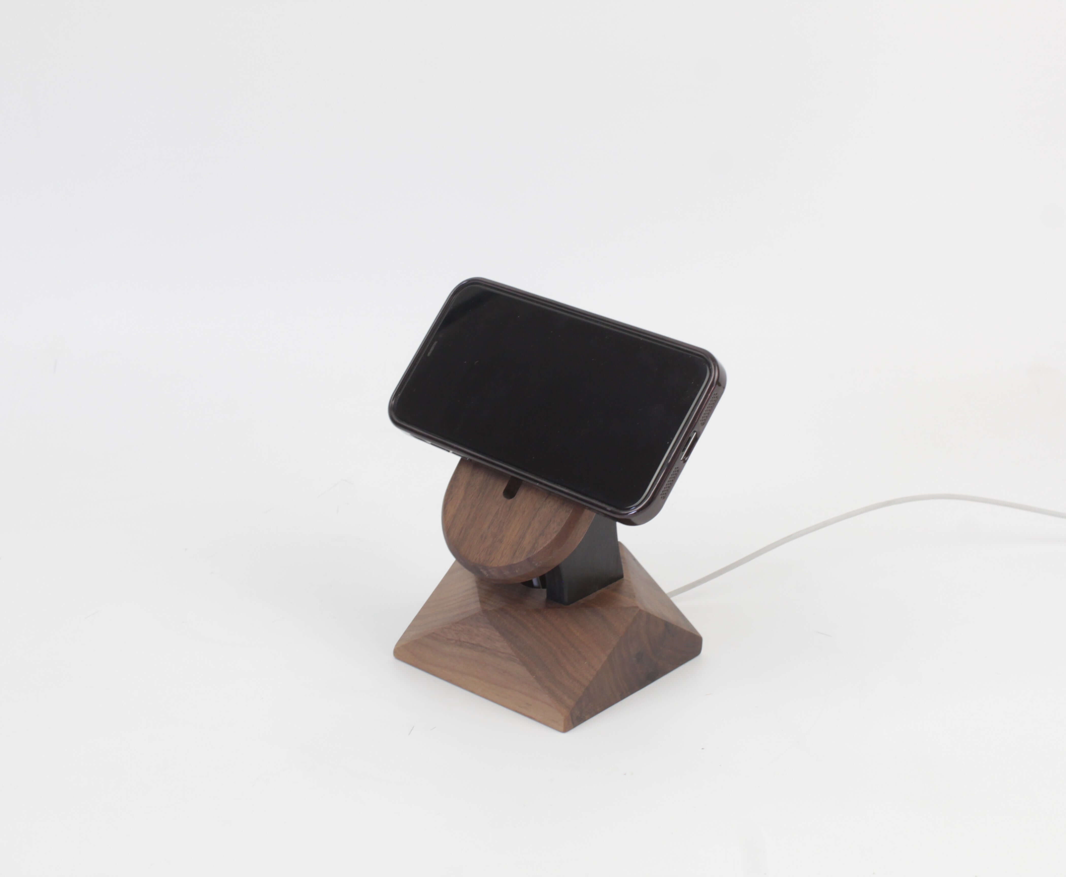 Handcrafted walnut MagSafe iPhone stand, featuring a minimalist design for wireless charging and modern iPhone accessories.