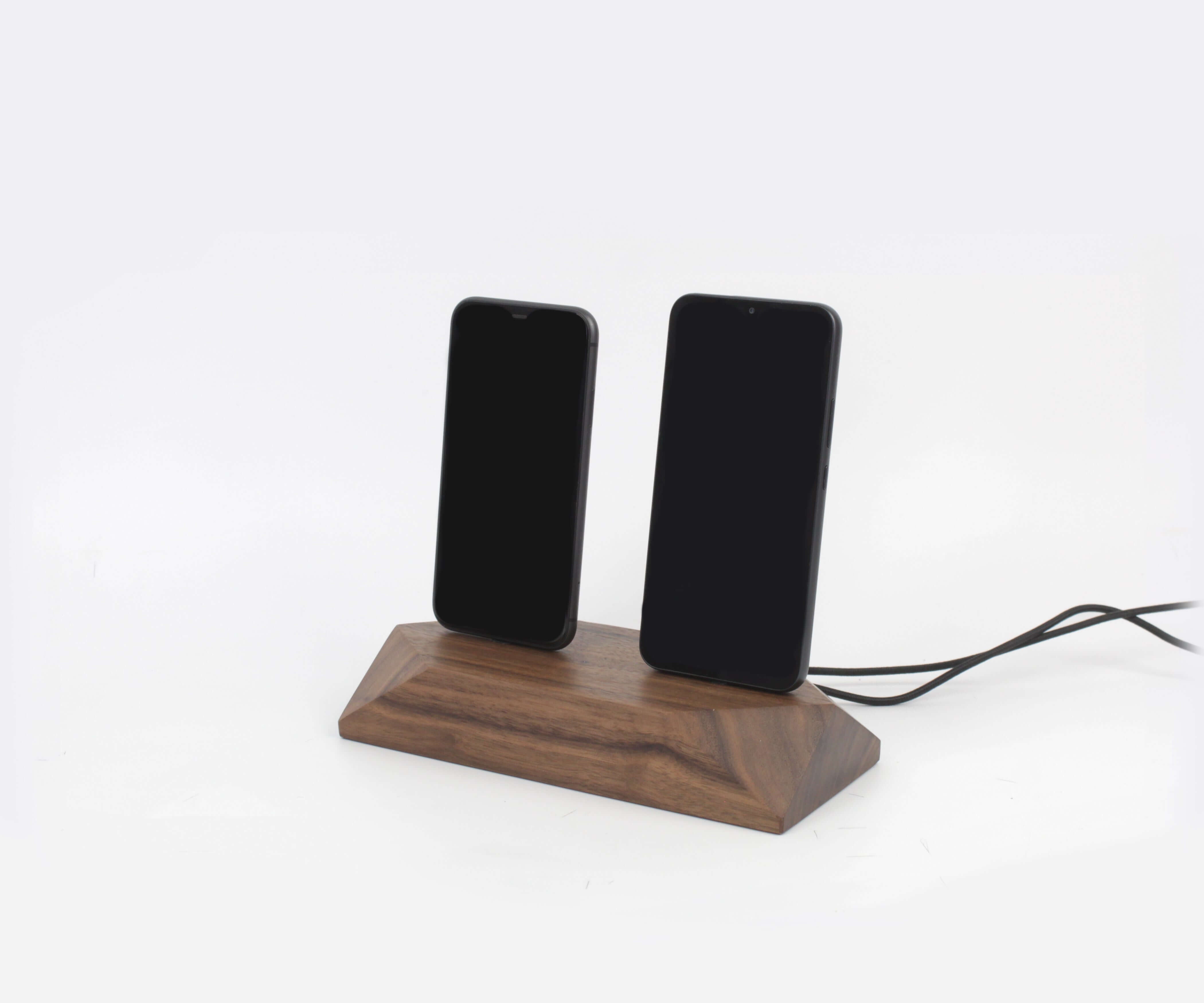 Dual phone dock in walnut finish charging two devices simultaneously, promoting a clutter-free workspace.