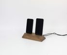 Dual phone dock in brown oak charging two devices simultaneously, ideal charging station for organized desks.